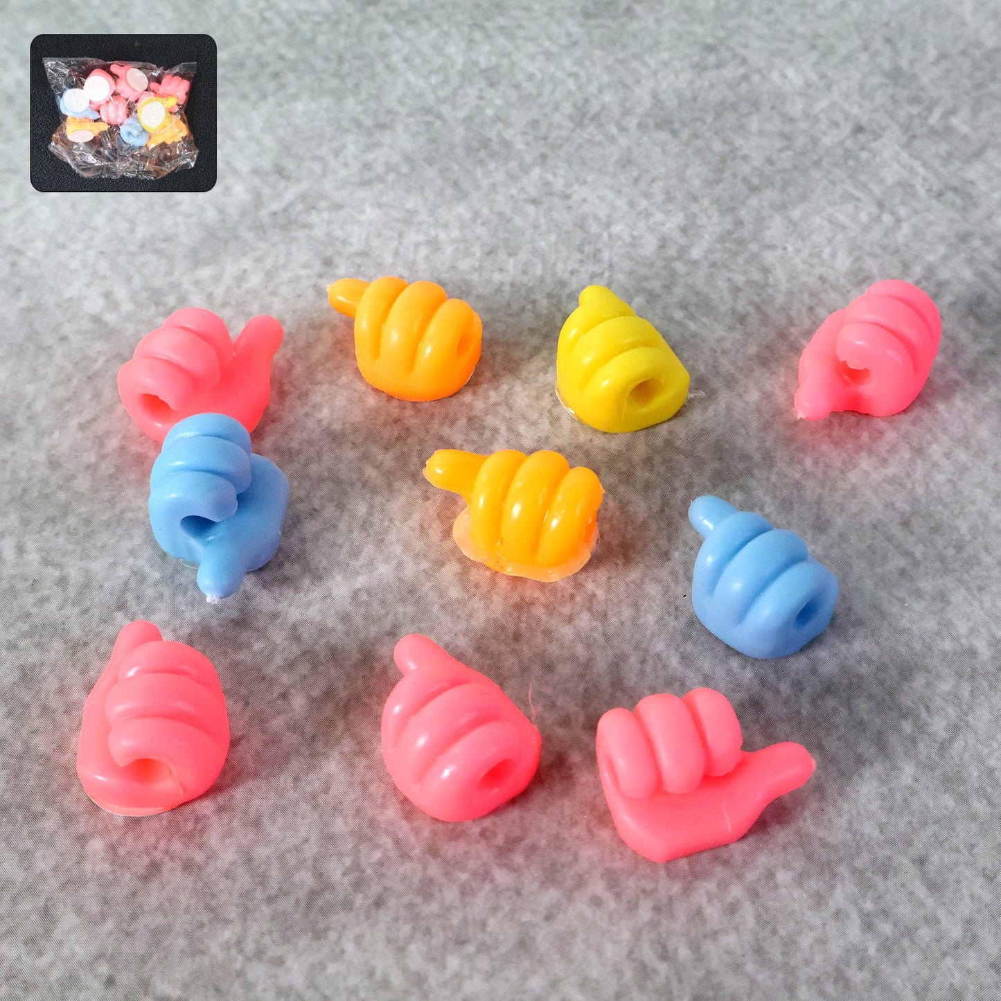 Set of 10 colourful mini utility hangers with an anti-slip thumb-style grip.