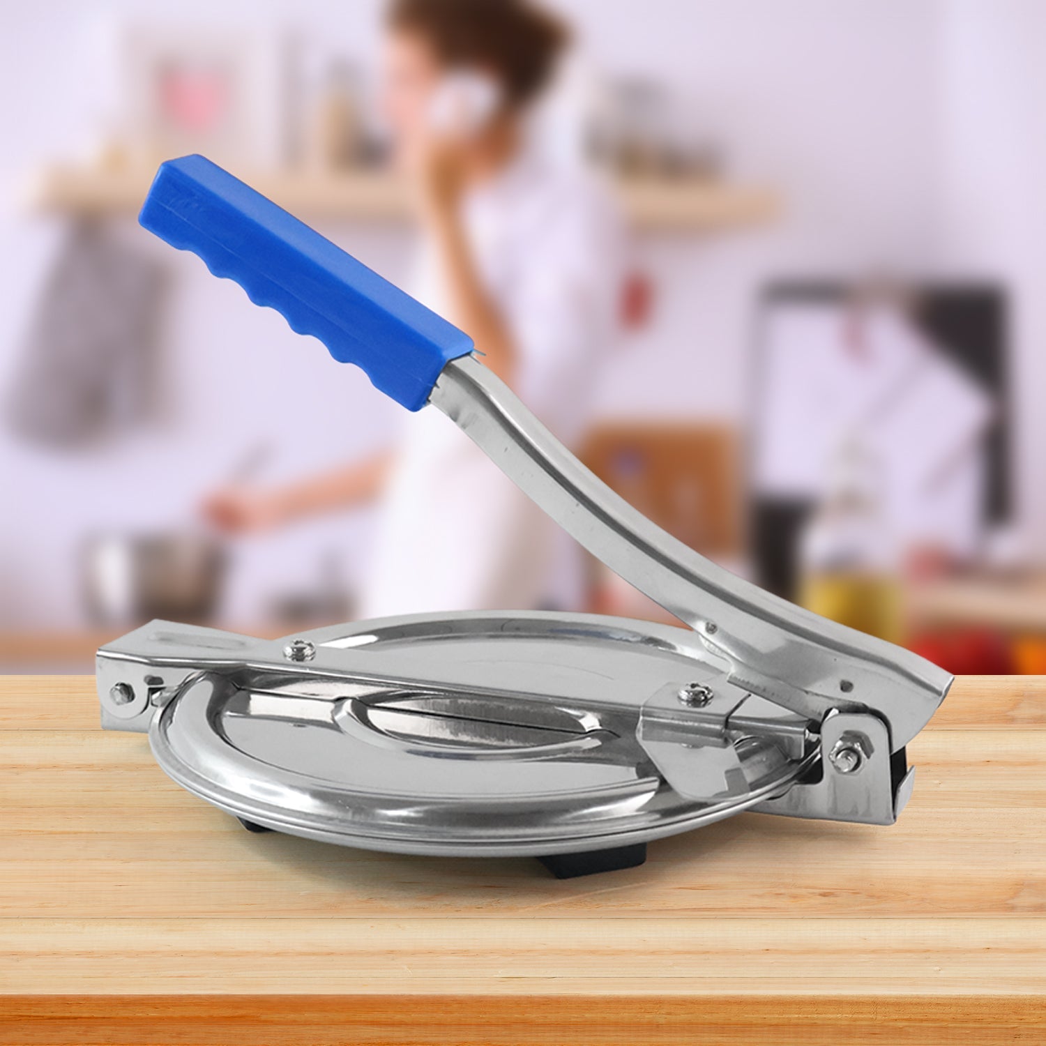 Puri Press Maker, stainless steel, with non-slip handle on a white background, ready for use.