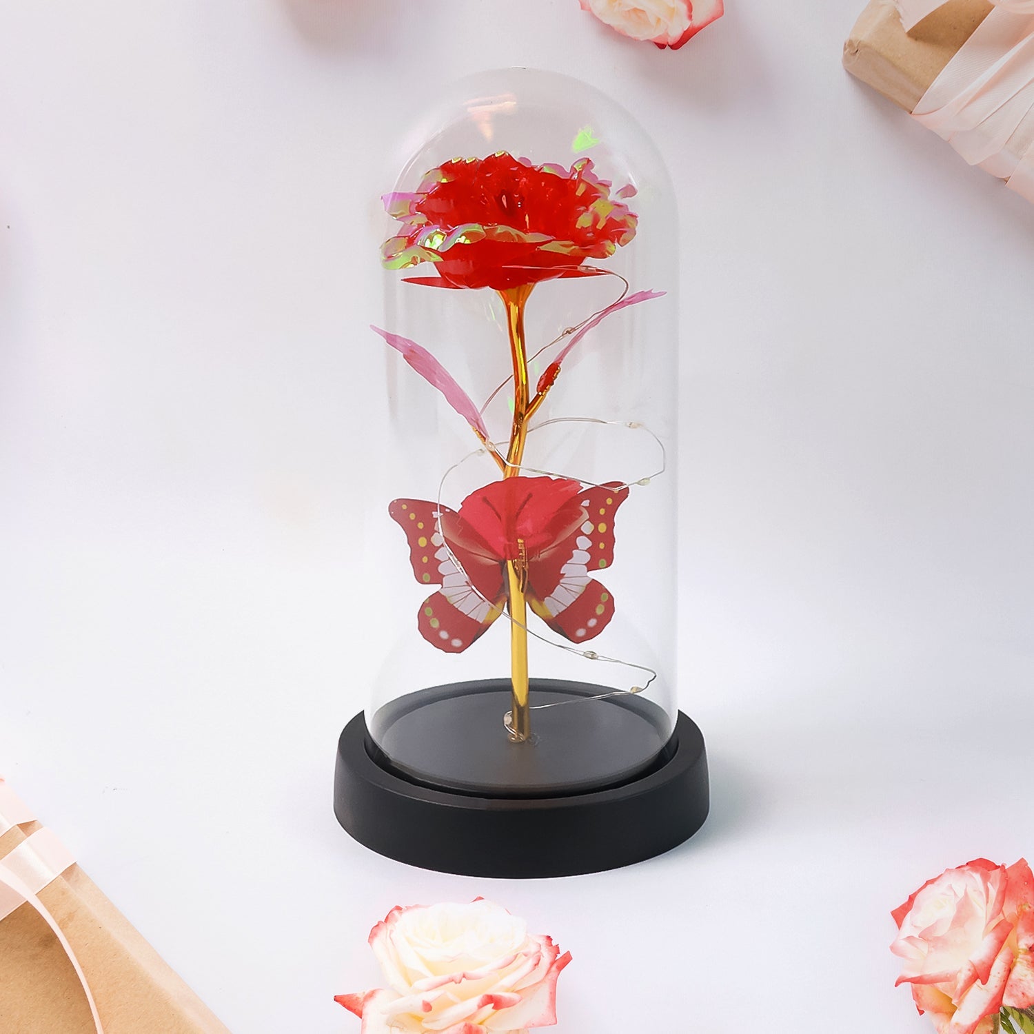 Crystal-clear plastic dome enclosing LED eternal rose with butterfly accent