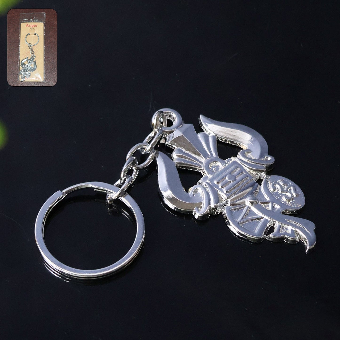 Silver metal Trishul Damru keychain shown on a white background