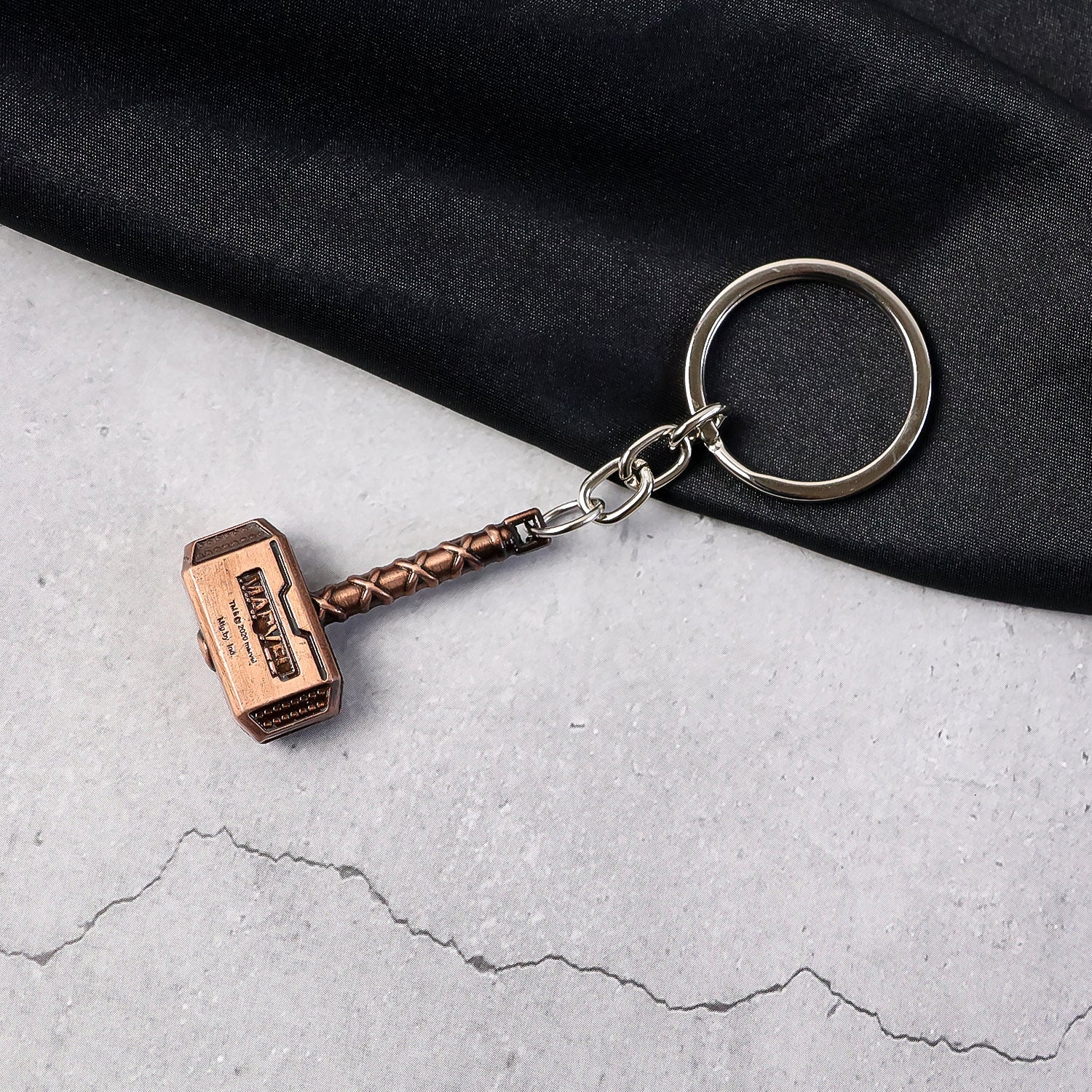 Metal Hammer Keychain with antique bronze finish on neutral background