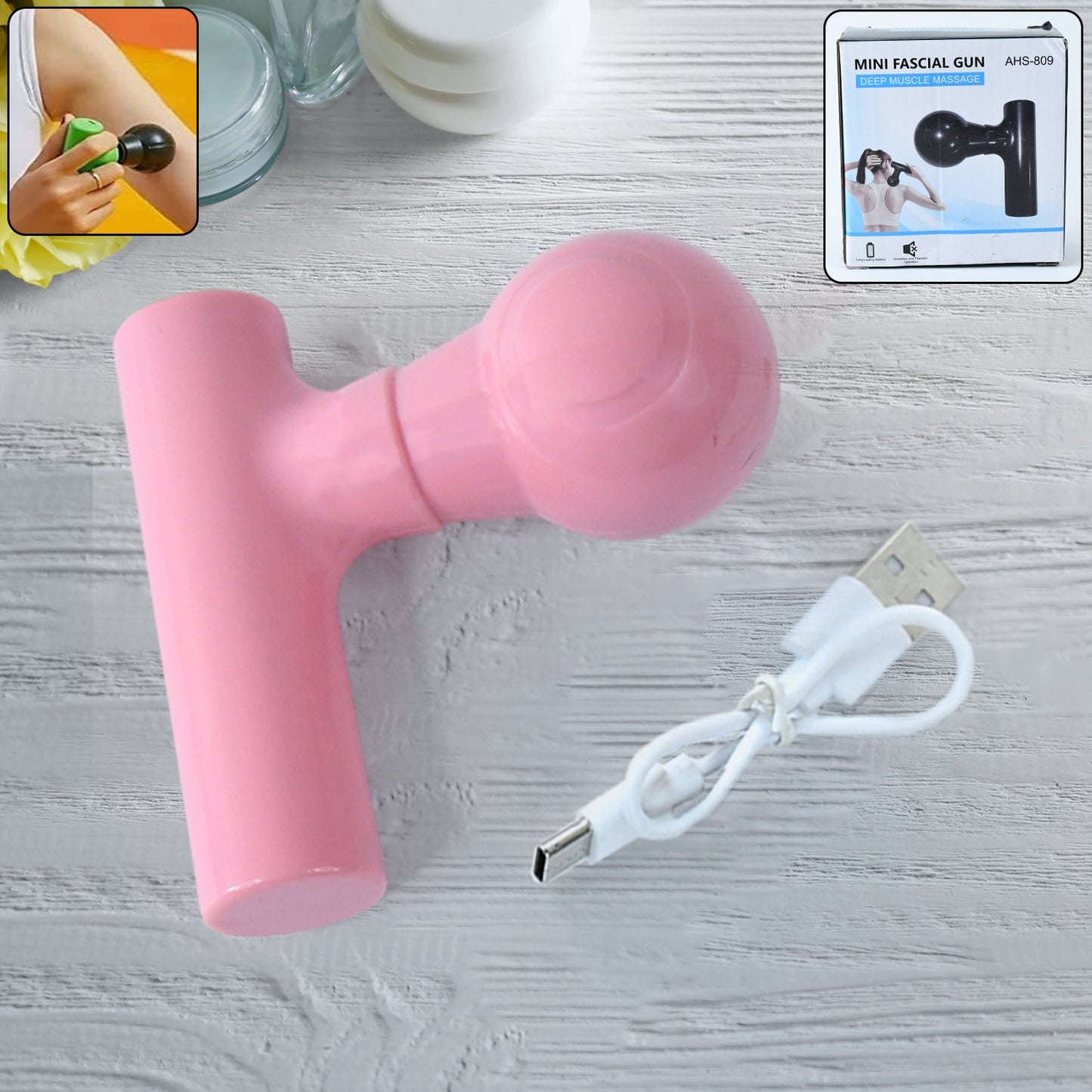 Compact black cordless body massager for pain relief, front view.