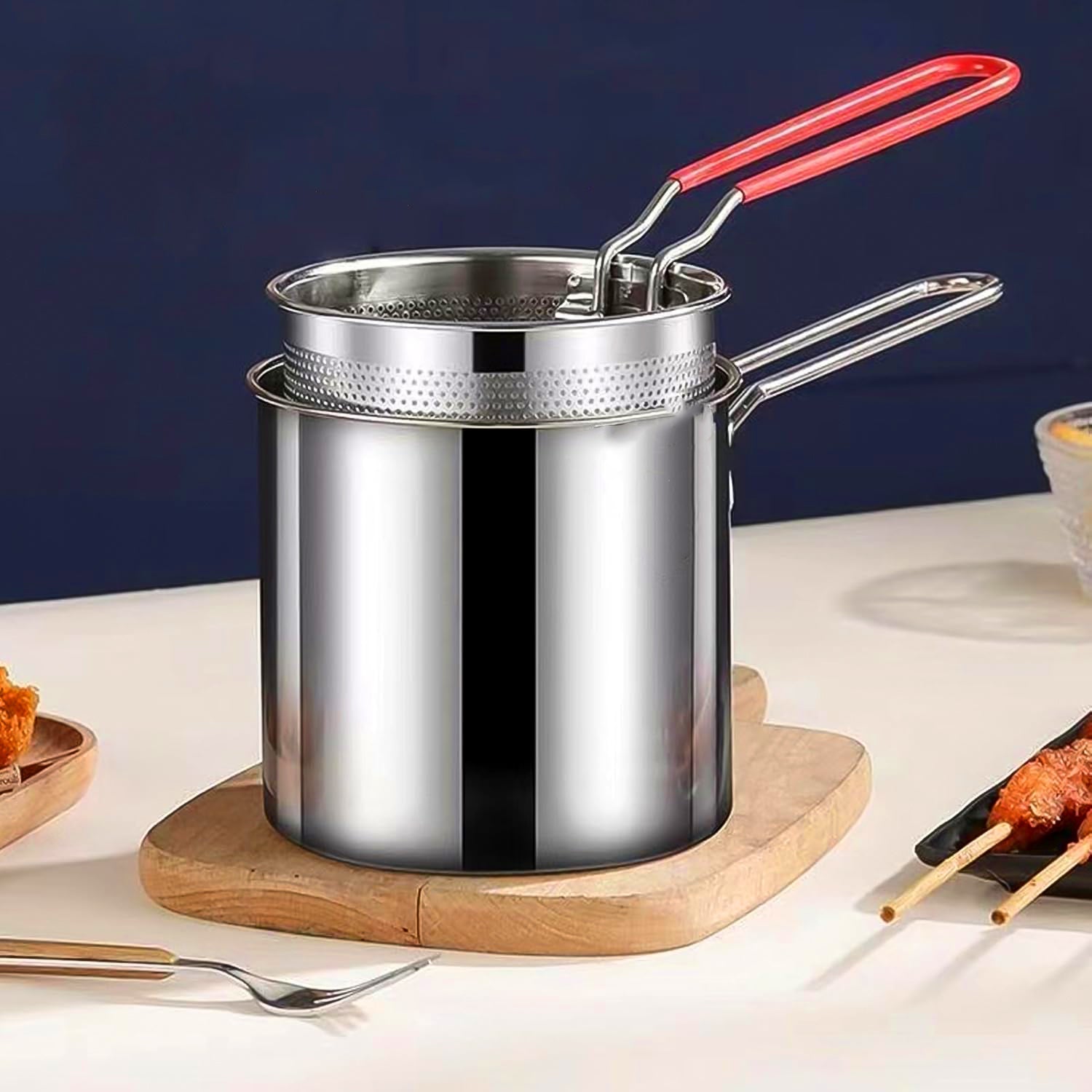 Delicious crispy fries freshly cooked and draining in the deep frying pot's strainer basket.