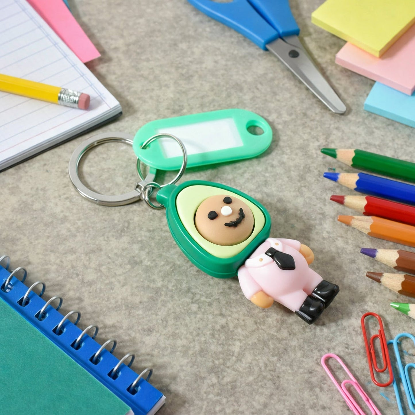 Cartoon avocado character keychain with smiling face on metal ring