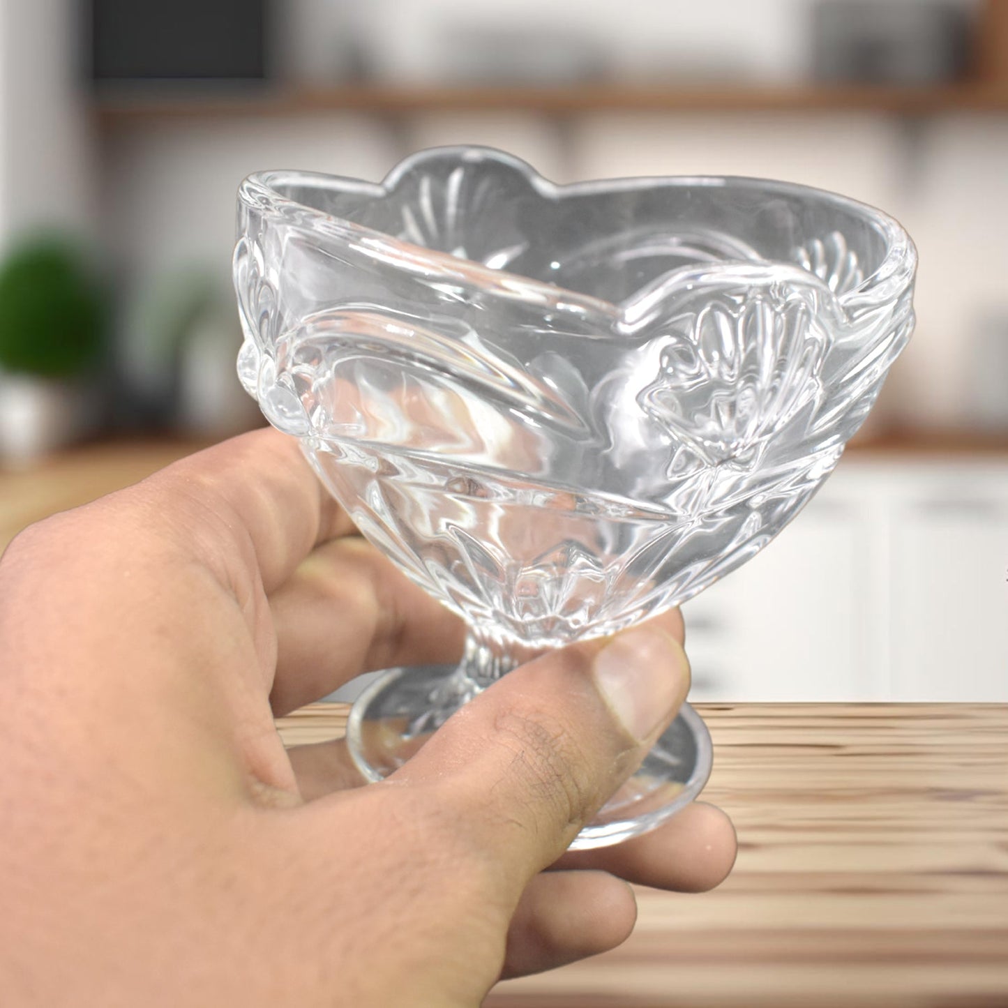 A single glass ice cream cup featuring the classic tulip shape.