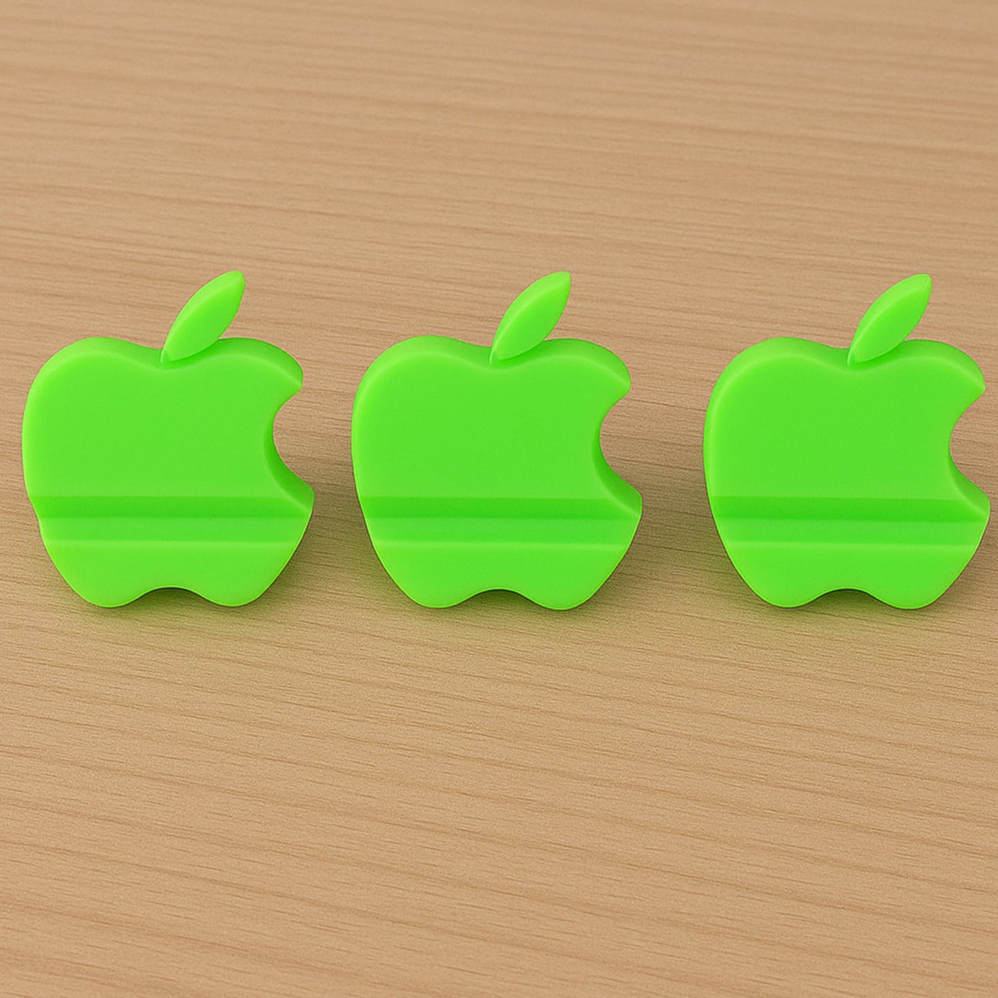 Assorted color apple-shaped mobile phone stands displayed together