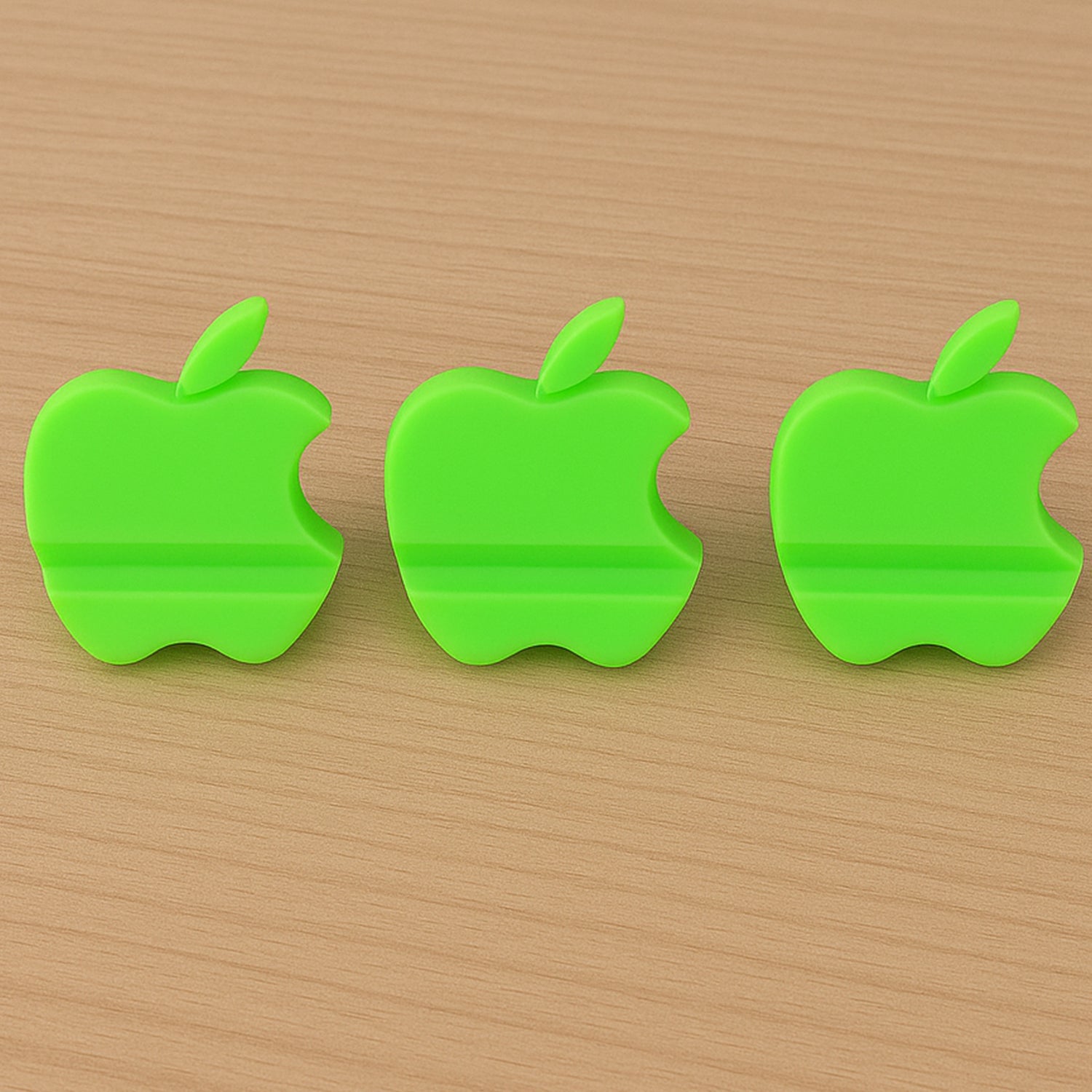 Assorted color apple-shaped mobile phone stands displayed together