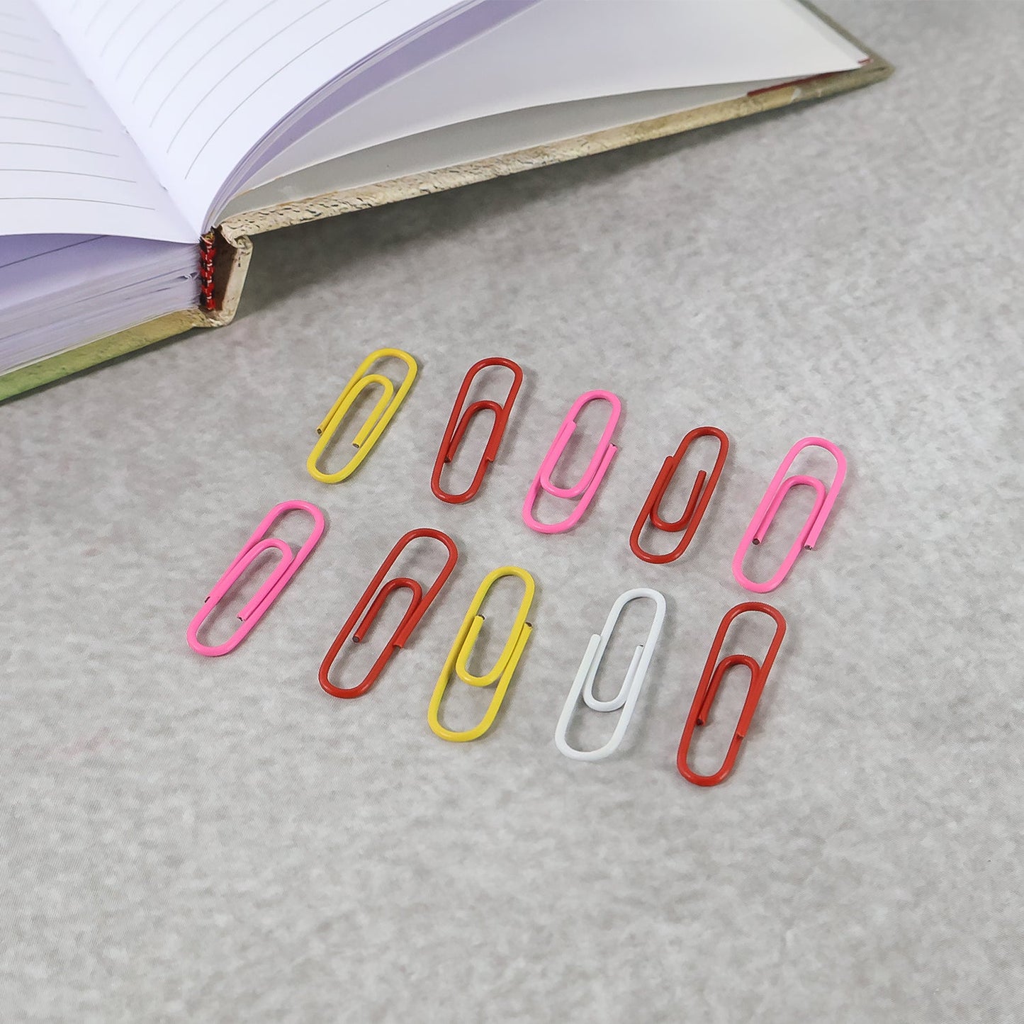 Mixed colour steel paper clips with protective vinyl coating to prevent paper damage and rust.