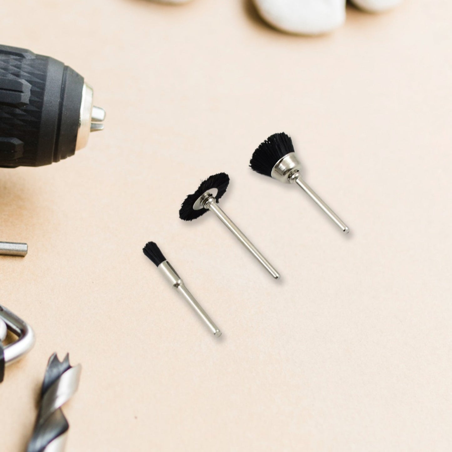 Pen-shaped brass wire brush attachment for precision cleaning with a drill.