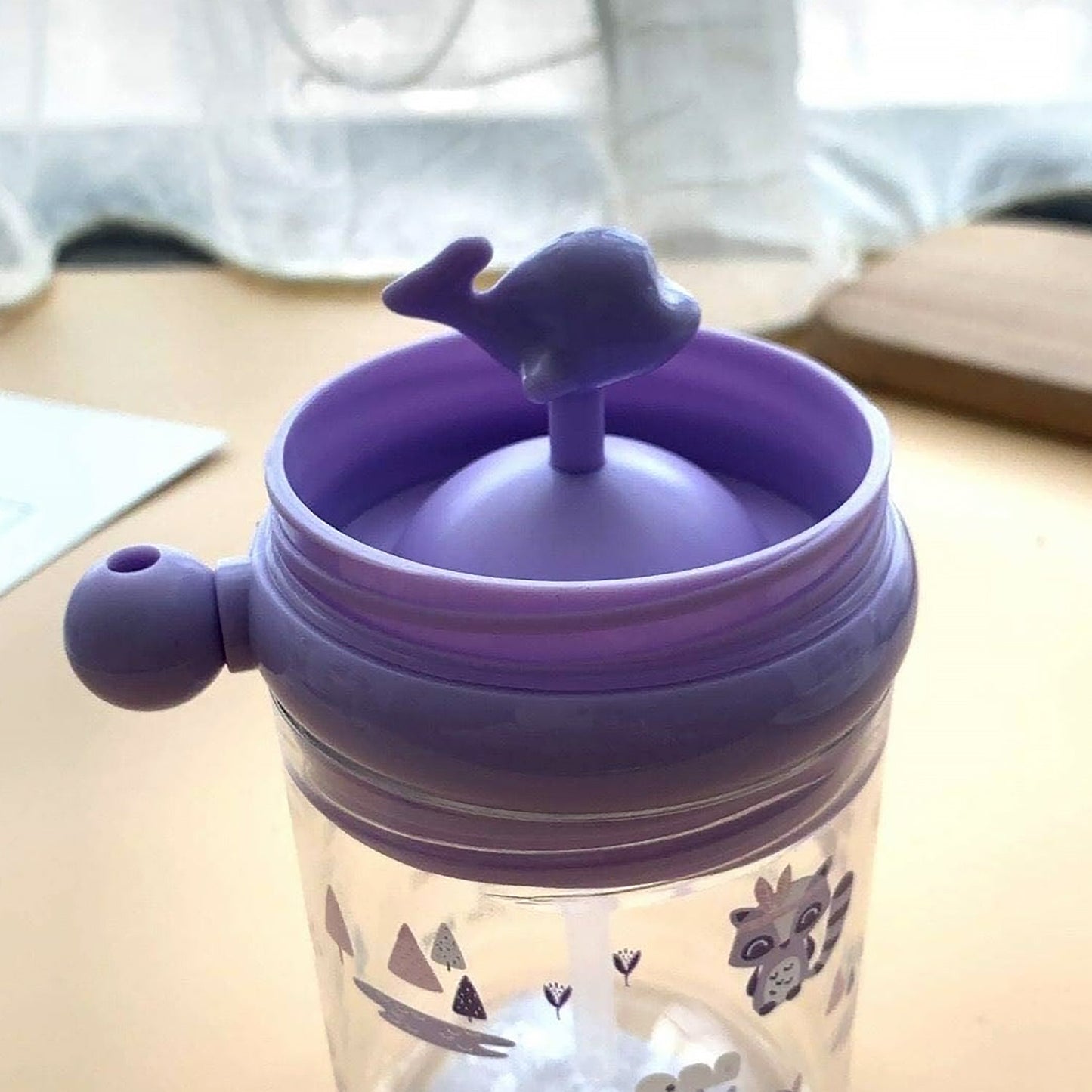 The Whale Spray Sippy Cup displayed in its colourful retail packaging, ideal for gifting.