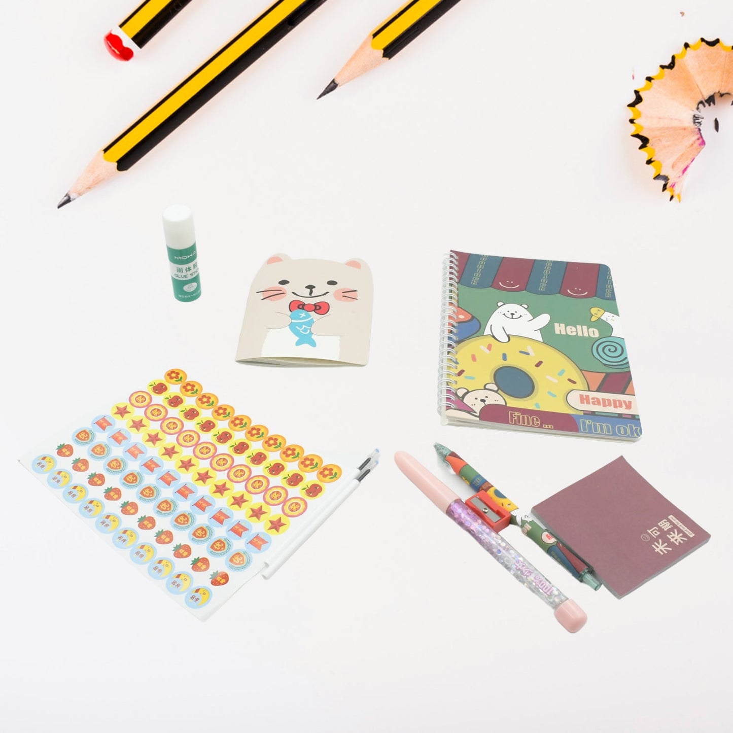Vibrant cartoon stationery box with a notebook, pen, and eraser for school kids.