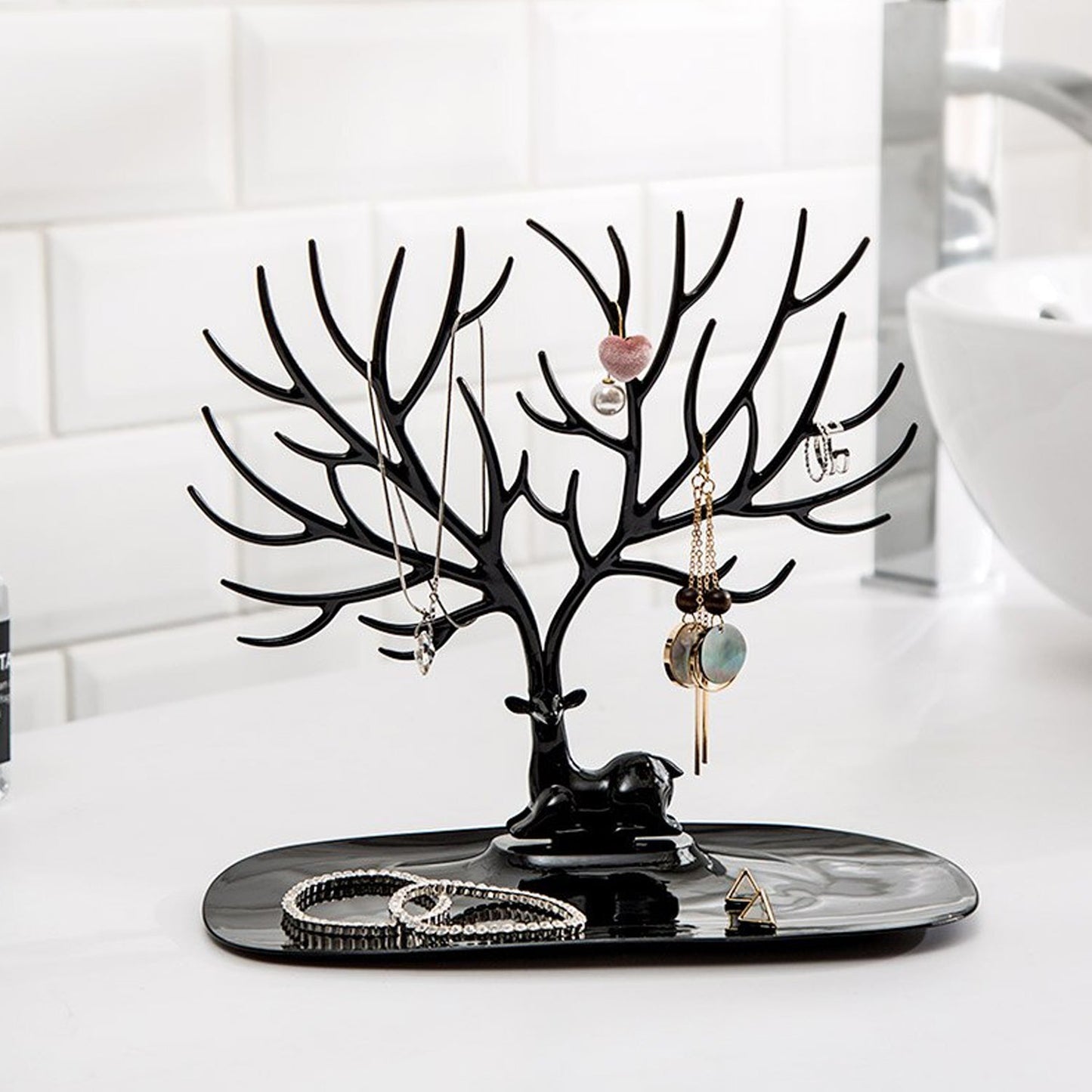 Side view of deer shaped jewellery holder showcasing antler branches and oval tray