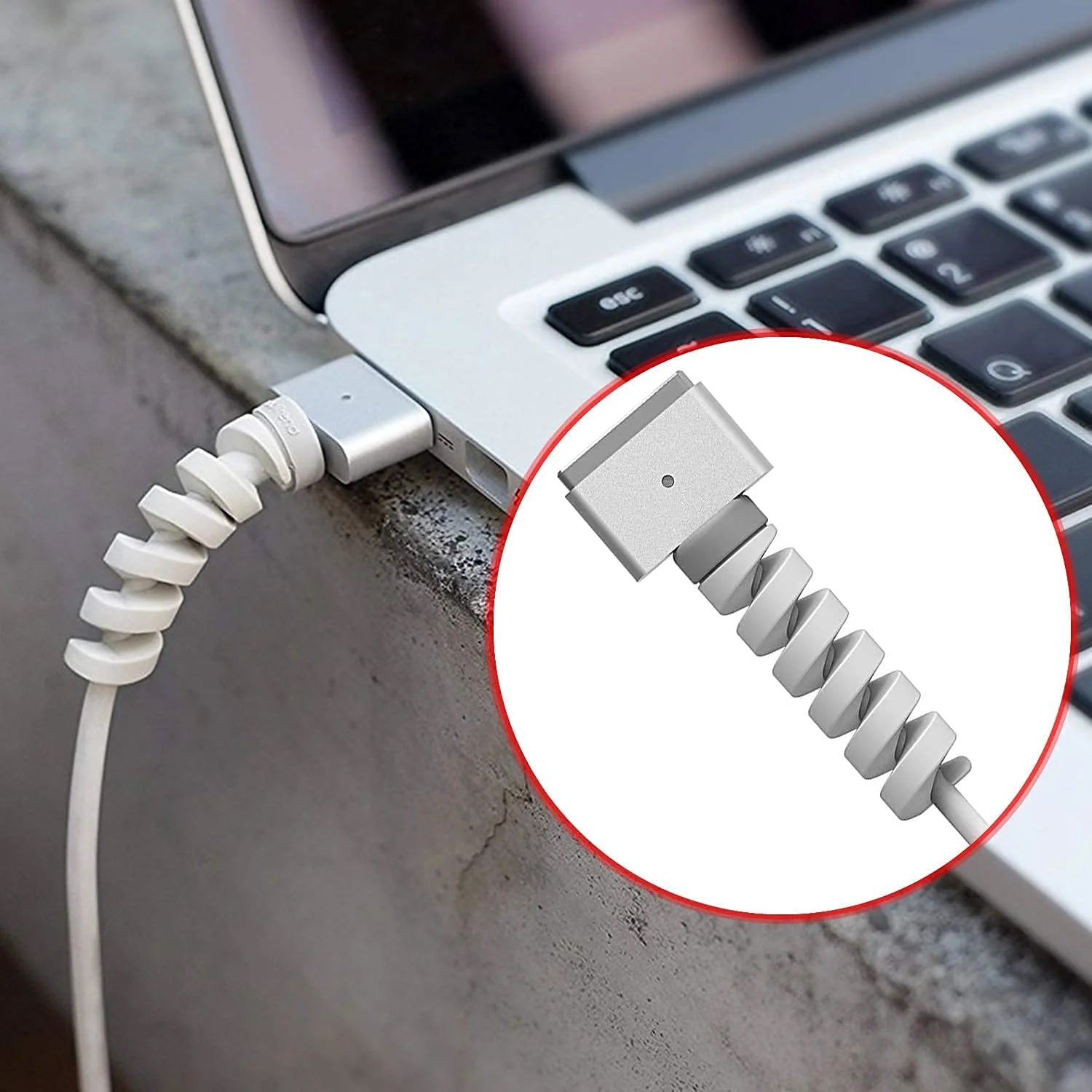 Single black spiral cable protector securely installed on a mobile charger cord.