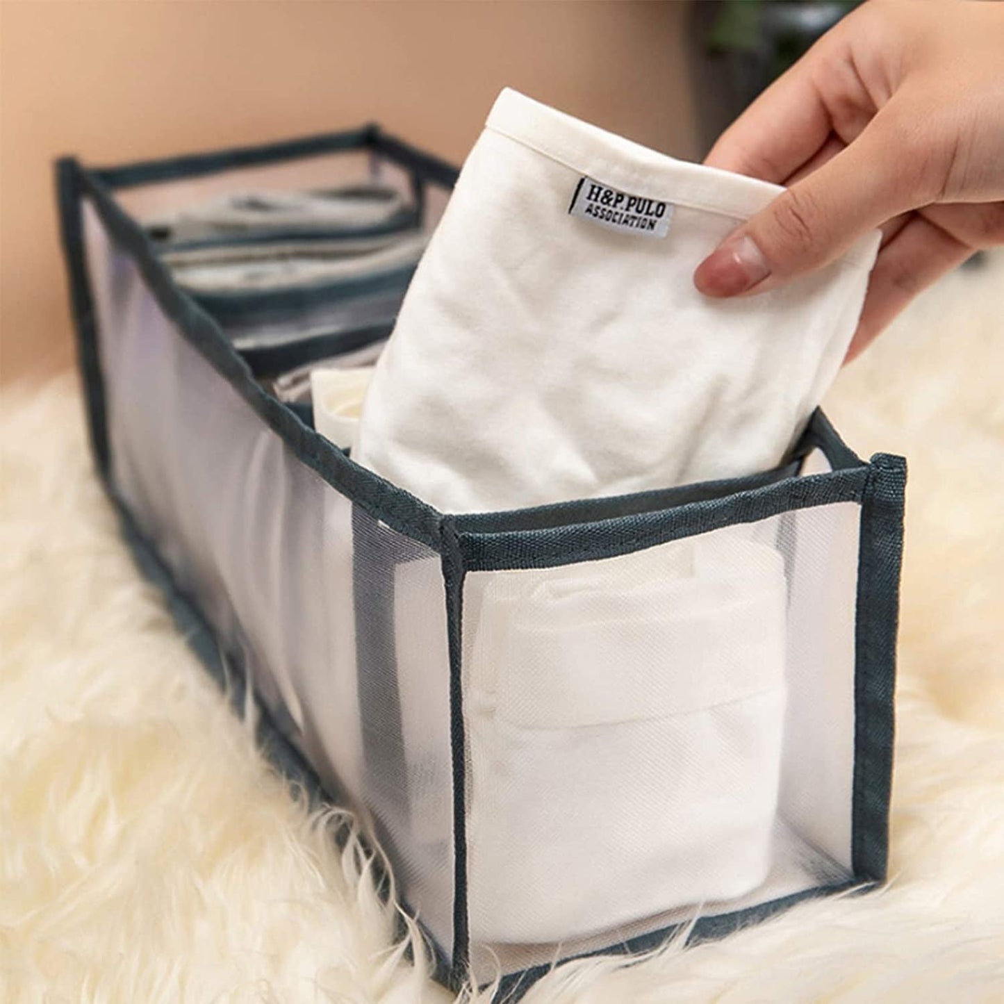 Organivo 7 Grid Clothes Organizer neatly storing folded jeans and t-shirts.
