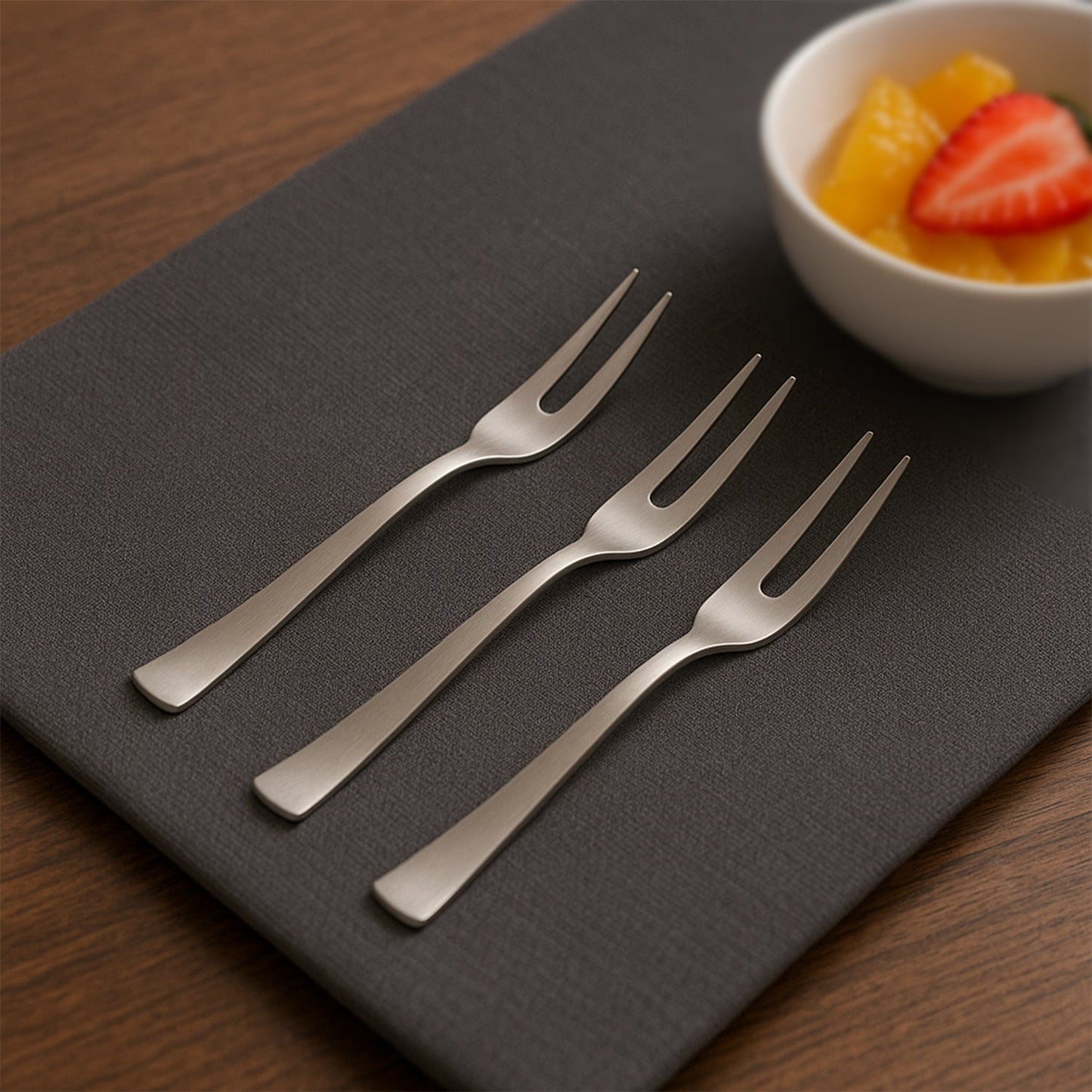 Set of six elegant stainless steel fruit forks with mirror finish