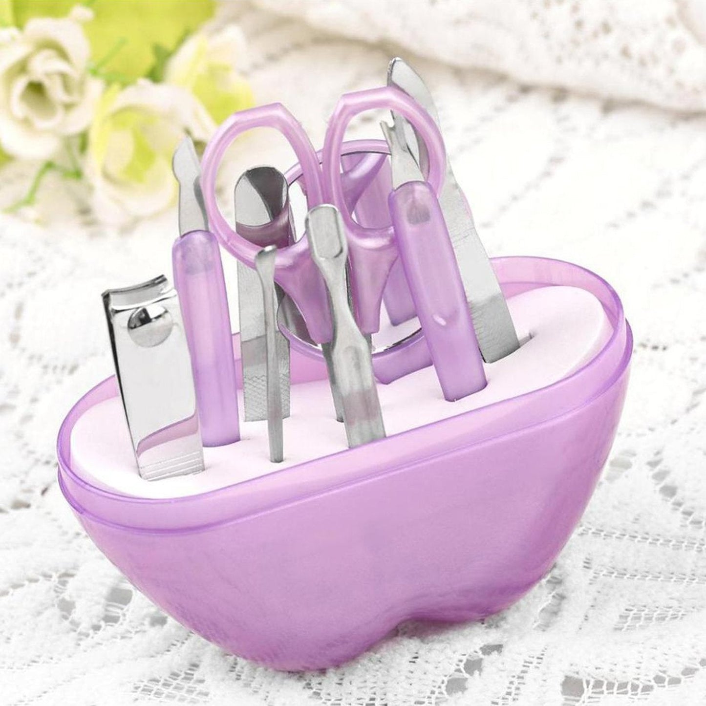 Compact apple-shaped manicure set with 8 stainless steel tools.