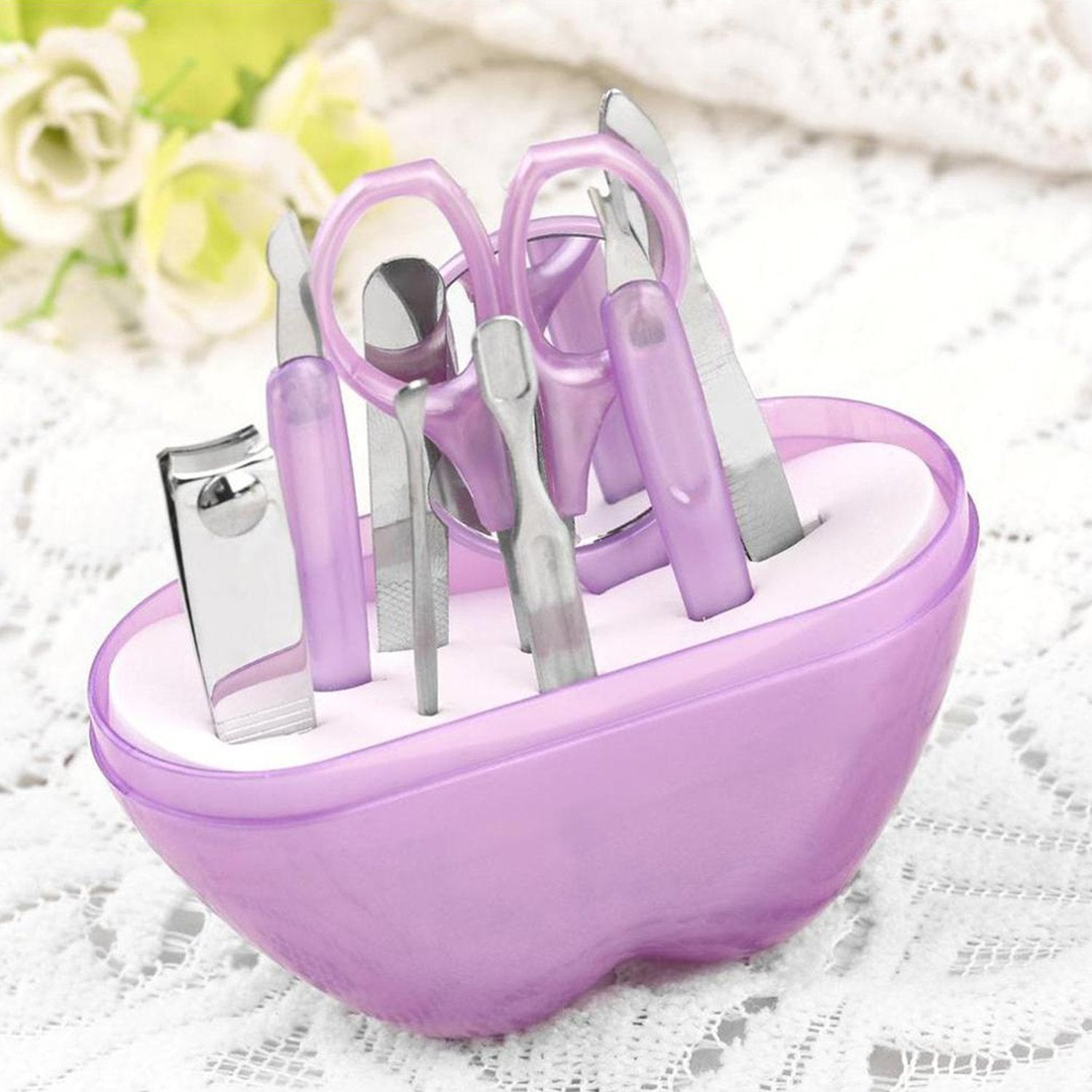 Compact apple-shaped manicure set with 8 stainless steel tools.