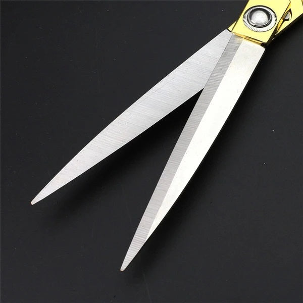 Close-up of the elegant golden handle of the 9.5-inch dressmaker shears.