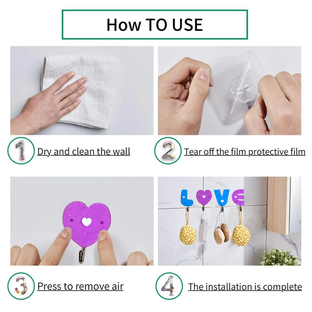Set of three love shape self adhesive hooks on a clean white wall.