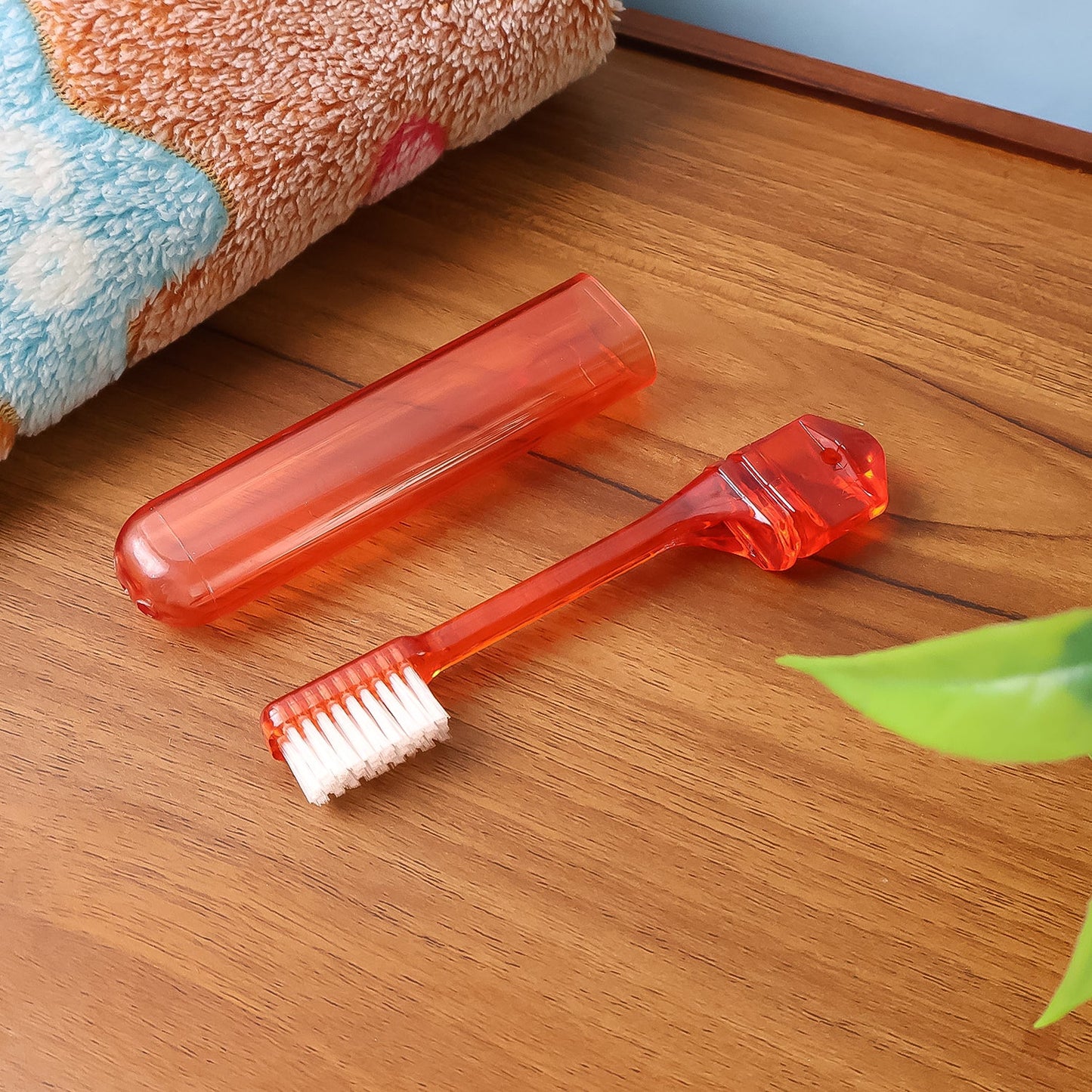 Travel toothbrush folded compactly to protect bristles from dirt.