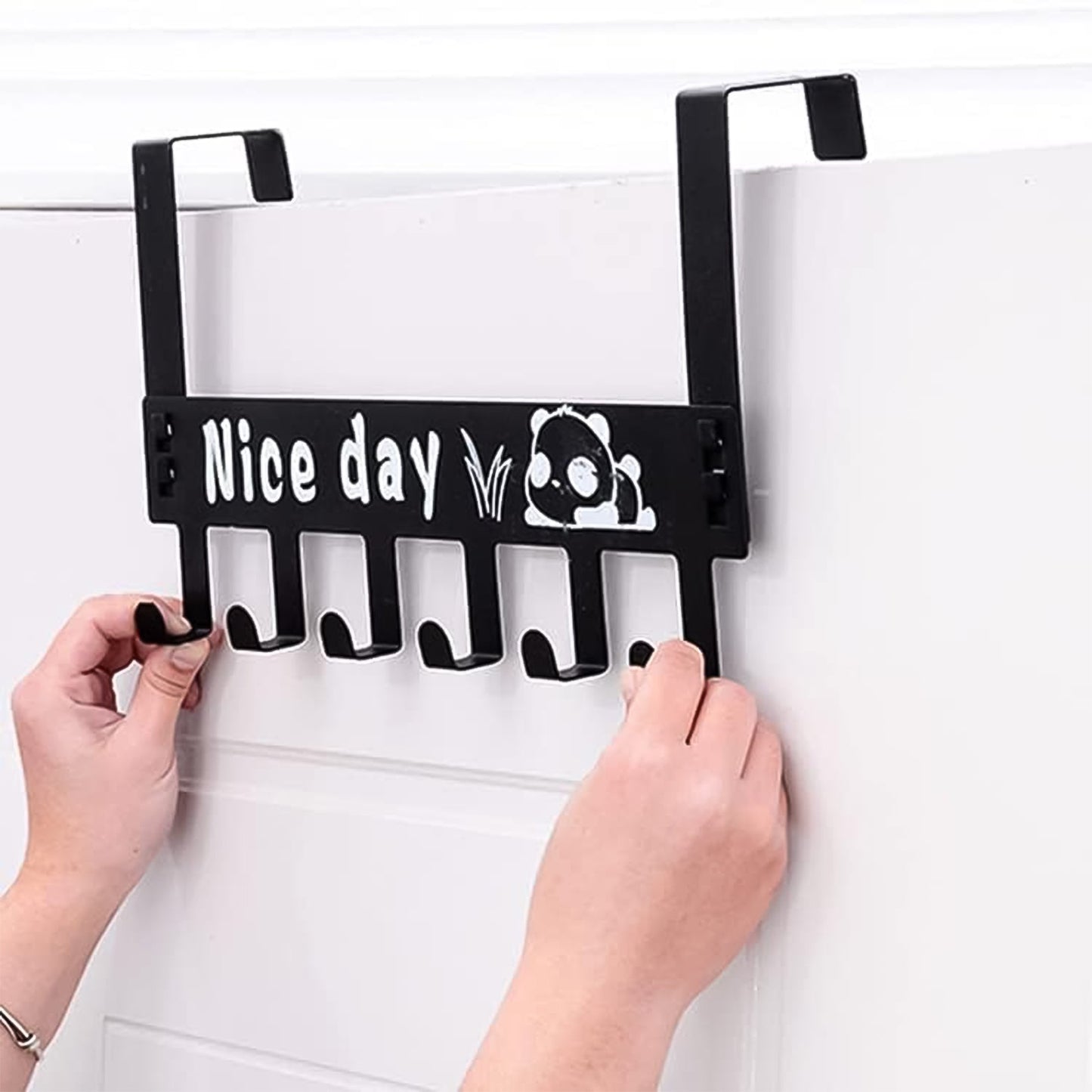 Black over door rack with six hooks for coats and towels hanging