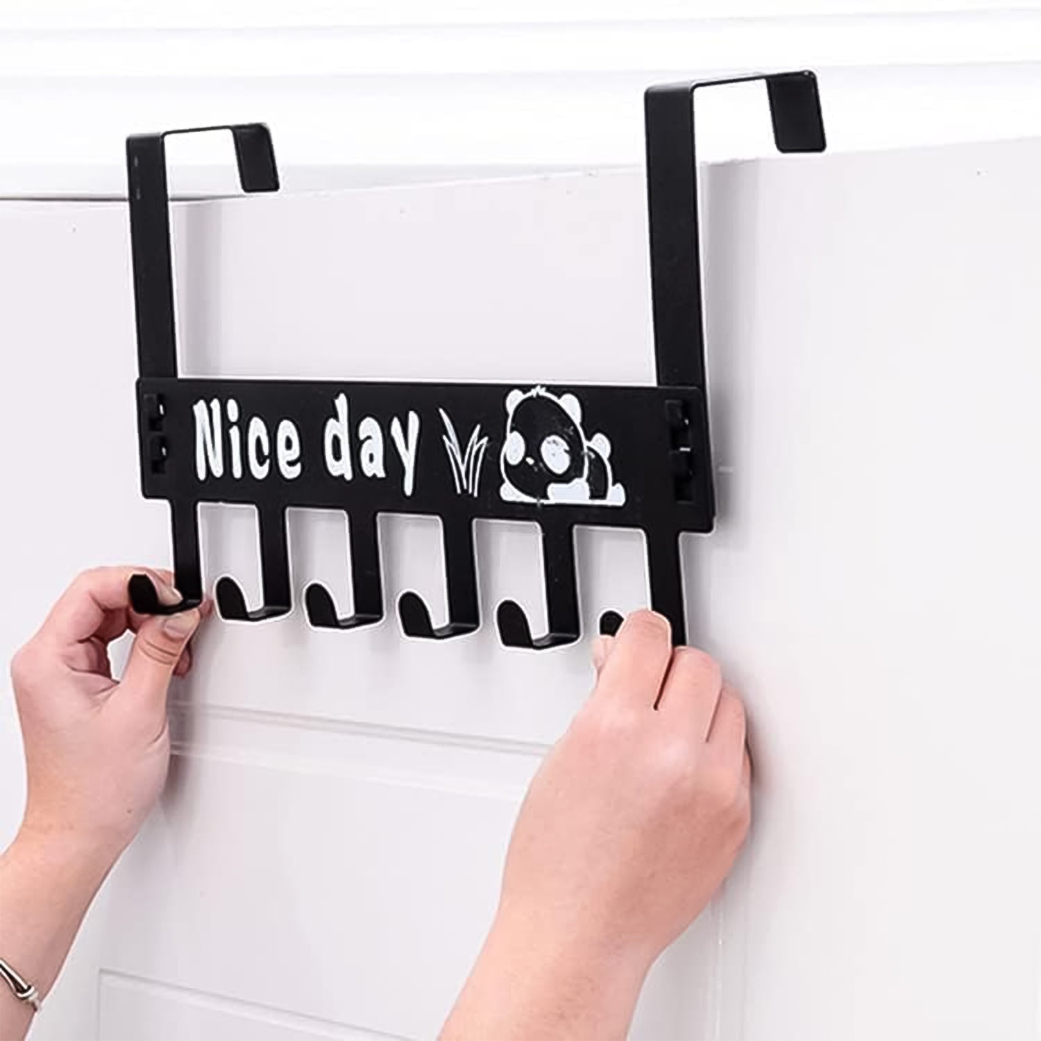 Black over door rack with six hooks for coats and towels hanging