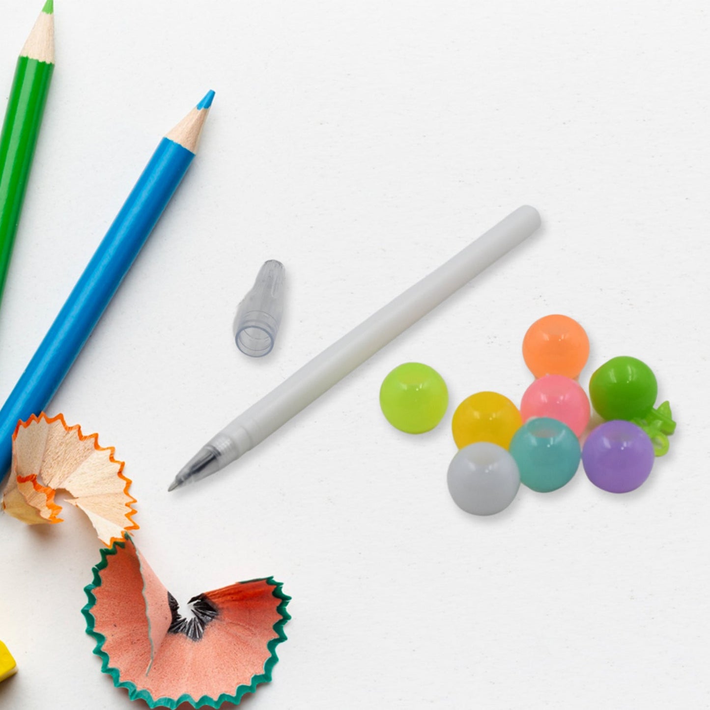 Attractive multicolor pearl pens arranged neatly, emphasizing their appeal as return gifts for kids.
