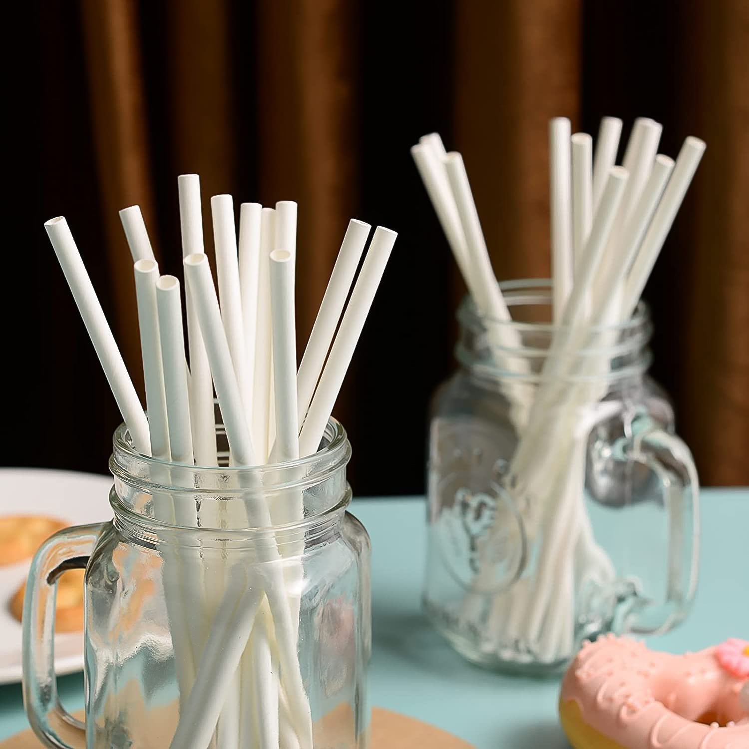 Plain white paper straws held by hands showing 200mm length and 6mm diameter