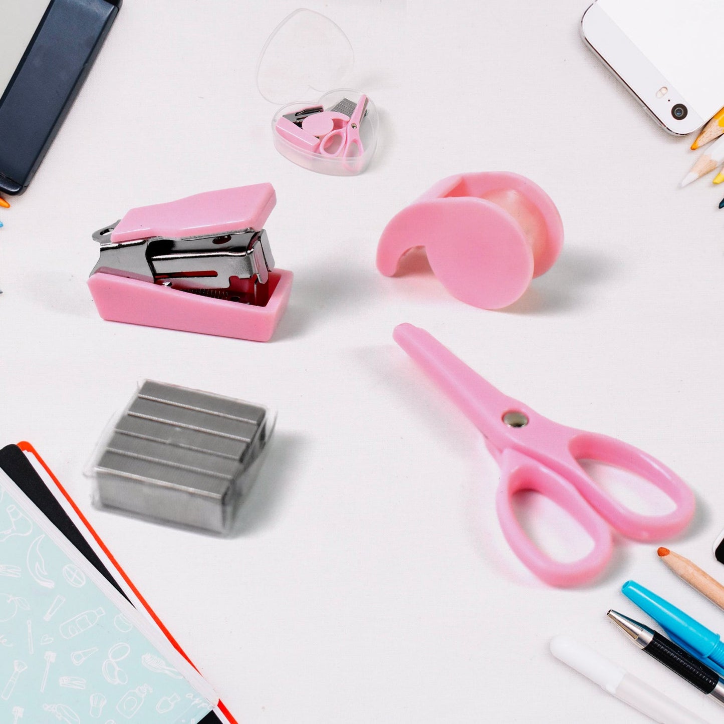 A clear plastic bottle containing a mini office stationery set, including a stapler, scissors, and tape dispenser.