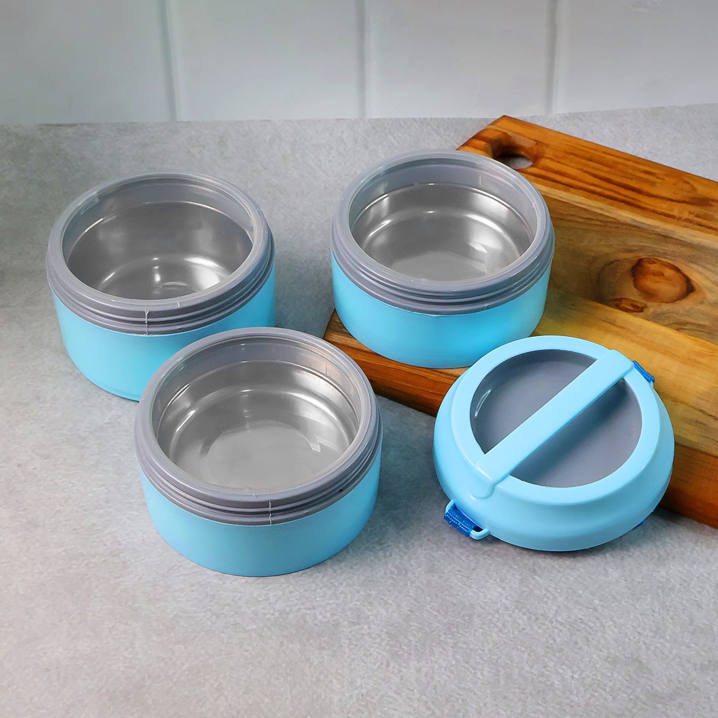 Side view of insulated lunch box featuring detachable strap and handle