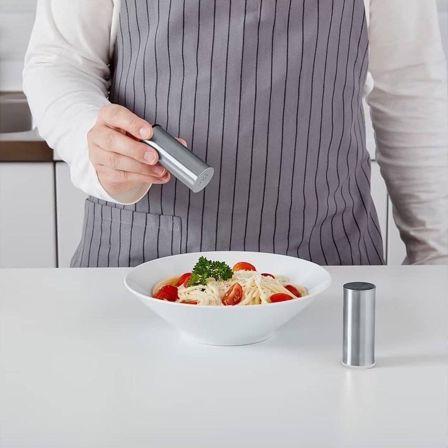 Close-up view of modern stainless steel salt and pepper shaker set