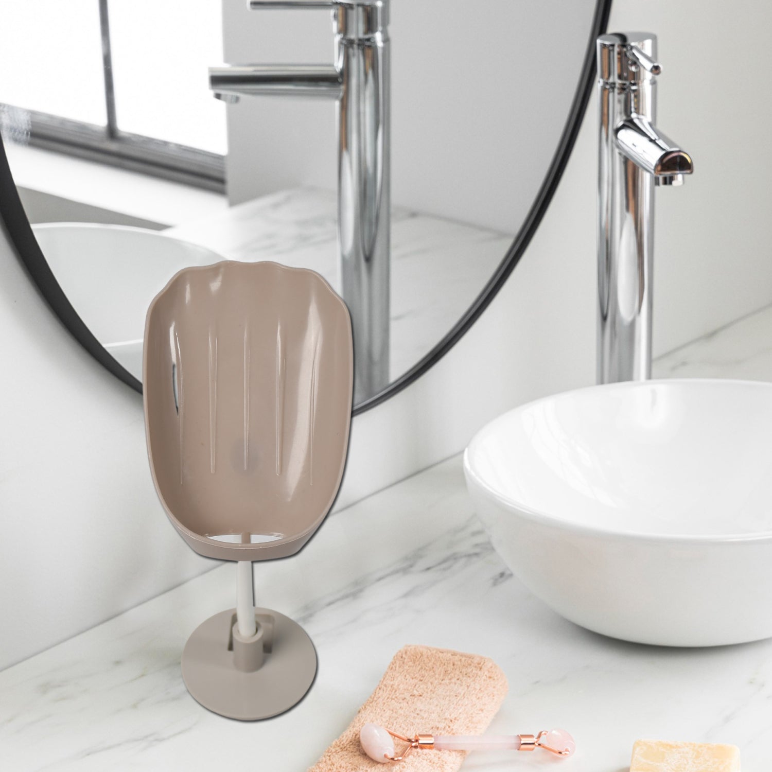 Self-draining soap holder in a bathroom, neatly holding a bar of soap and a scrubber.