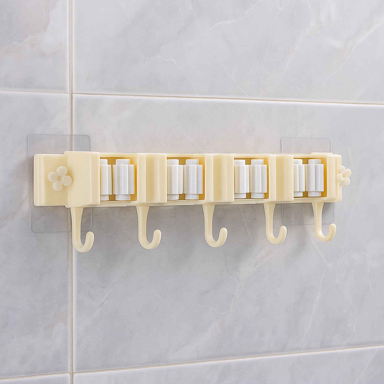 Self-adhesive broom and mop holder rack mounted on wall with utility hooks