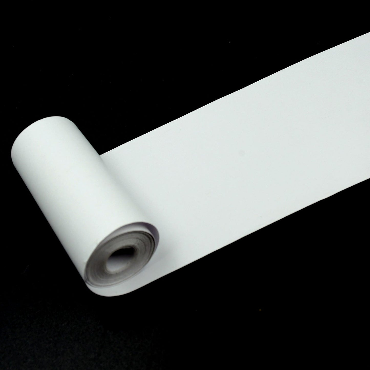 A thermal printer paper roll showcasing a crisp, clear black and white printed image.