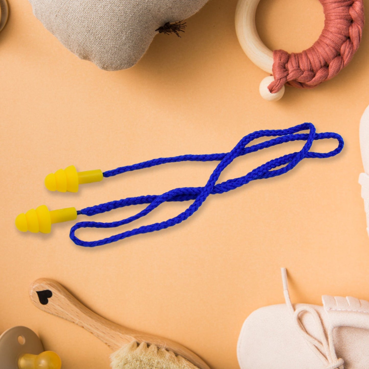 Pair of soft silicone ear plugs with a connecting cord for easy handling.