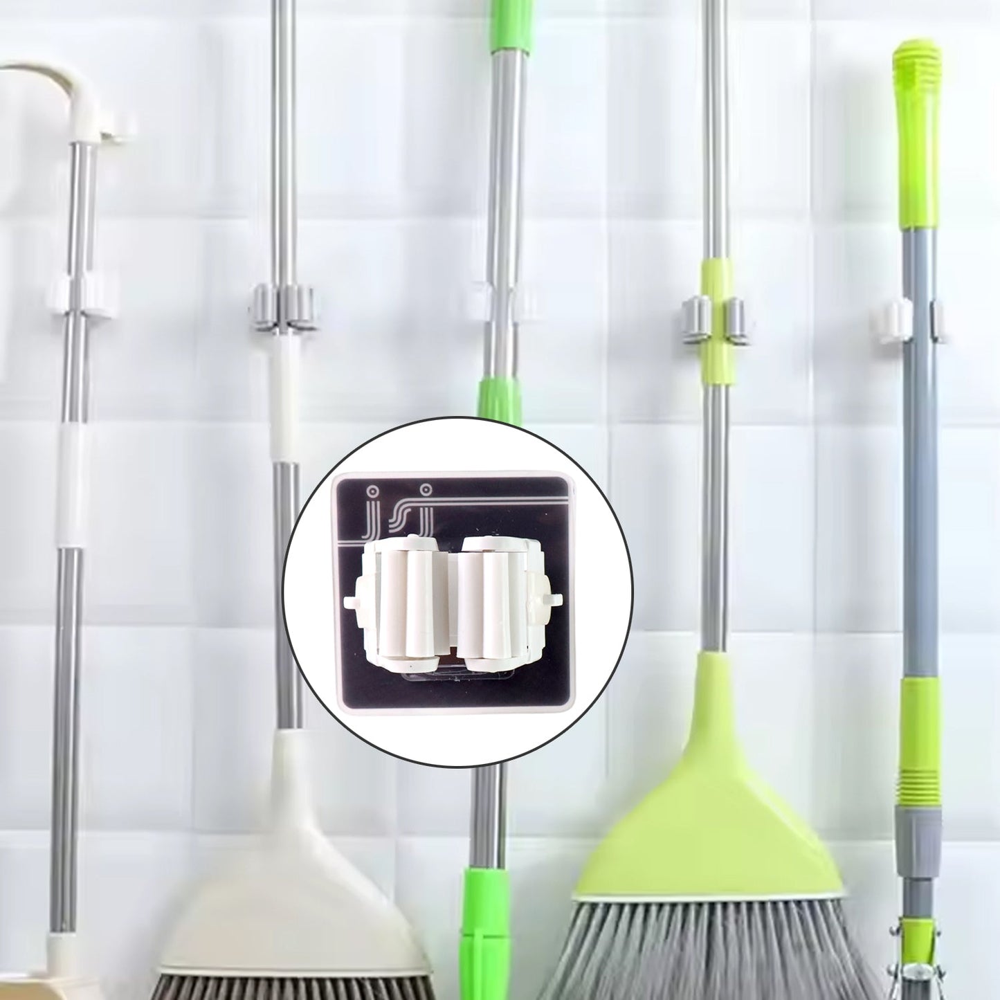 Single adhesive mop holder securely holding a mop on a wall.