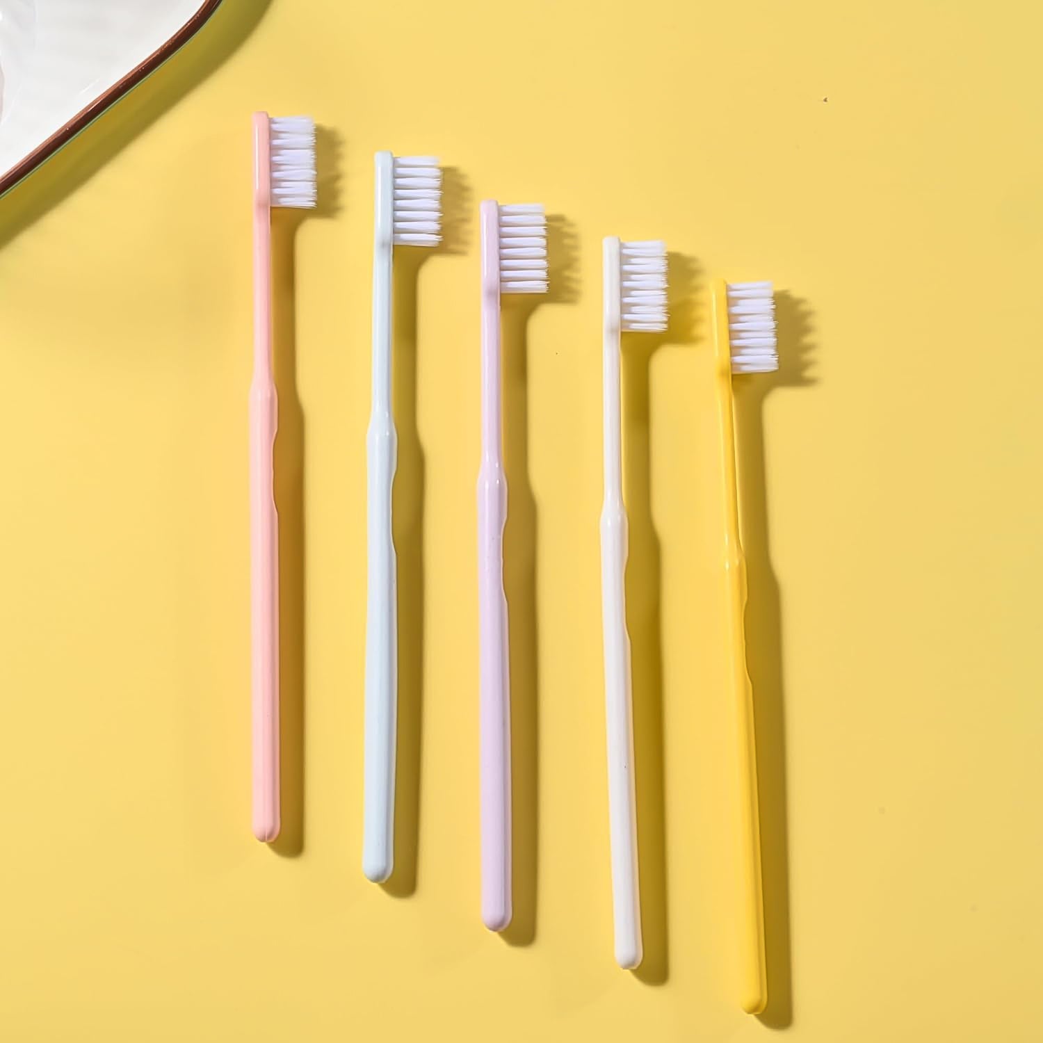 Arrangement of multicolor soft plastic toothbrushes, showcasing the variety in the family pack.
