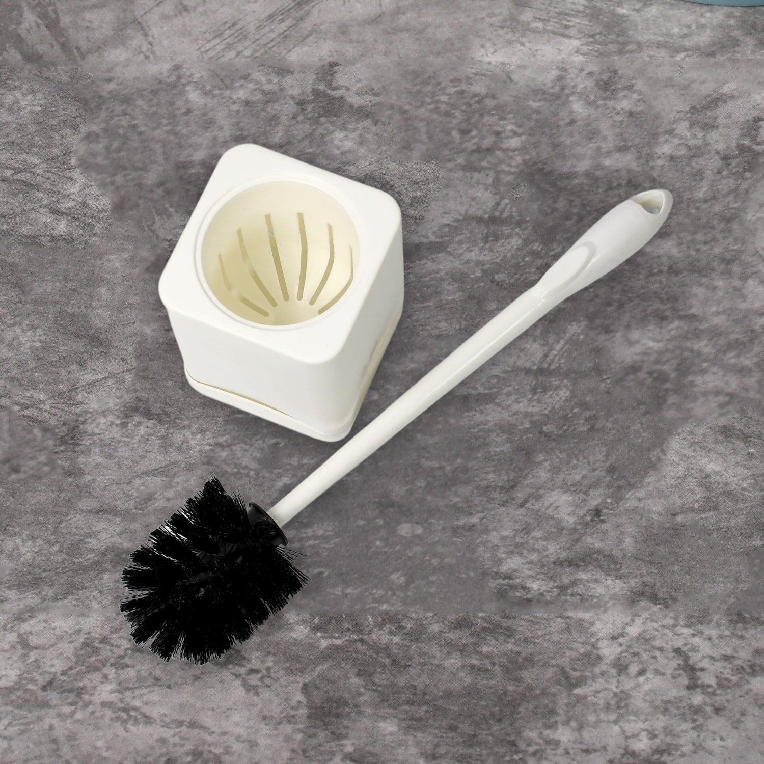 Complete toilet brush and holder unit, ready for immediate use.