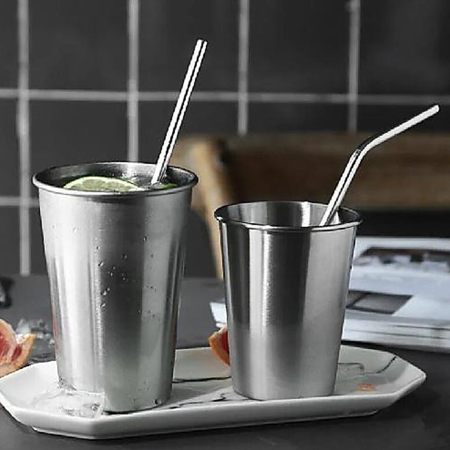 A sleek stainless steel straw elegantly placed next to a refreshing beverage.