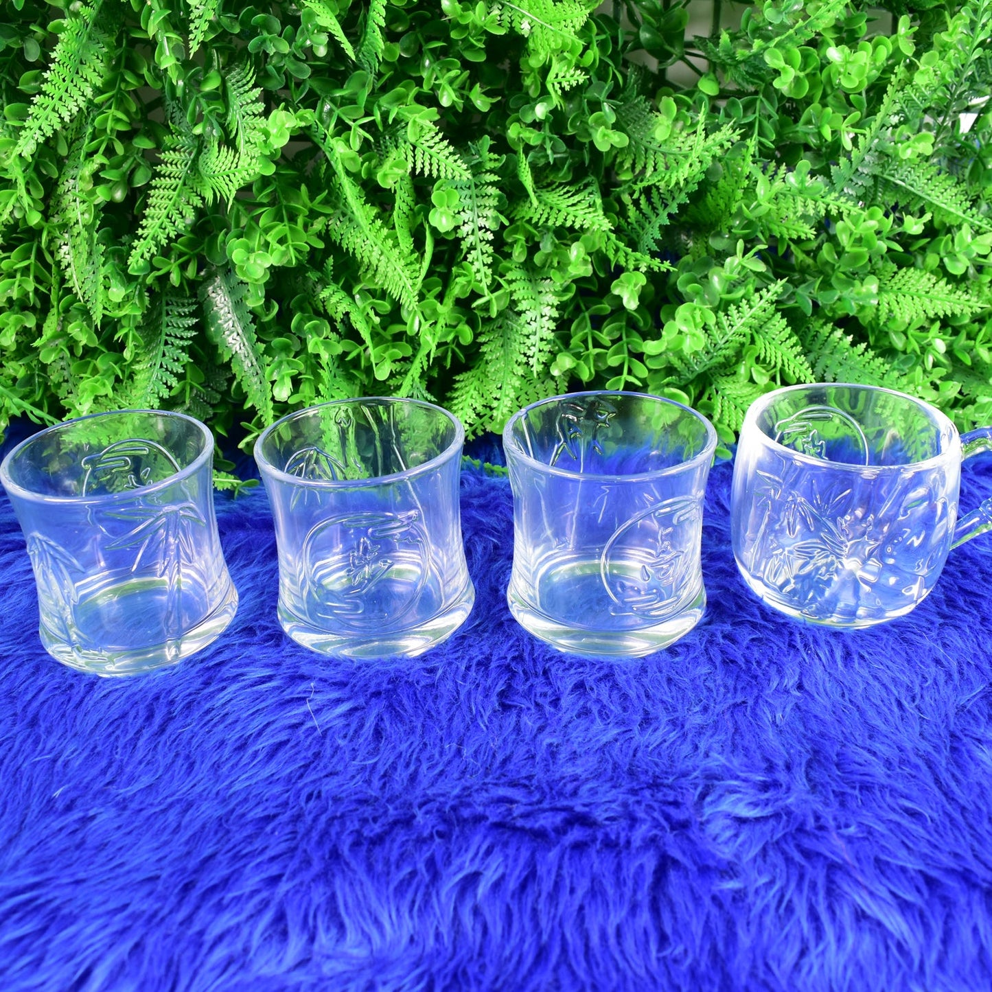 TableNest Glass Drinkware Set with textured mugs and tumblers on a light background.