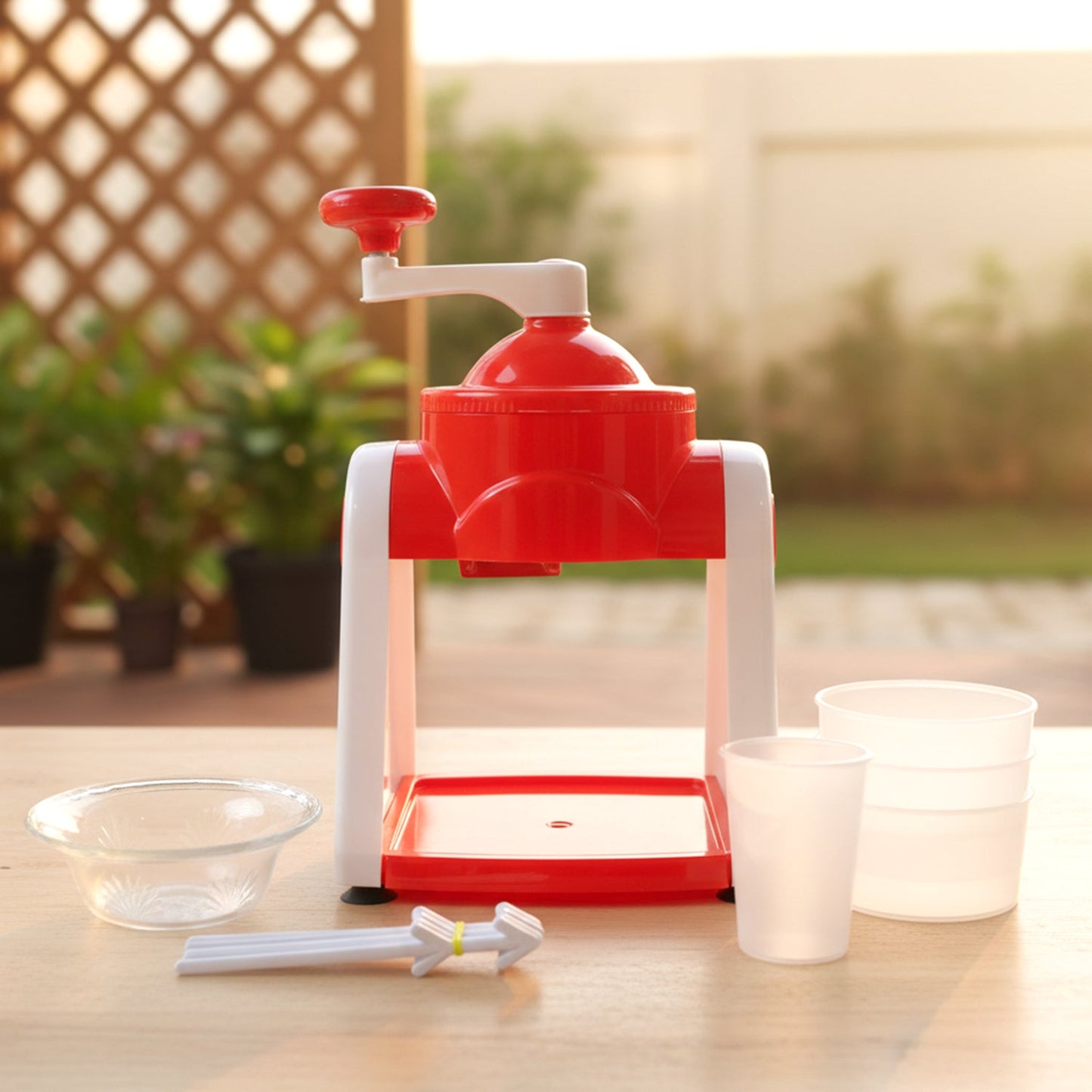 Hand operated ice slush maker in use crushing ice cubes efficiently
