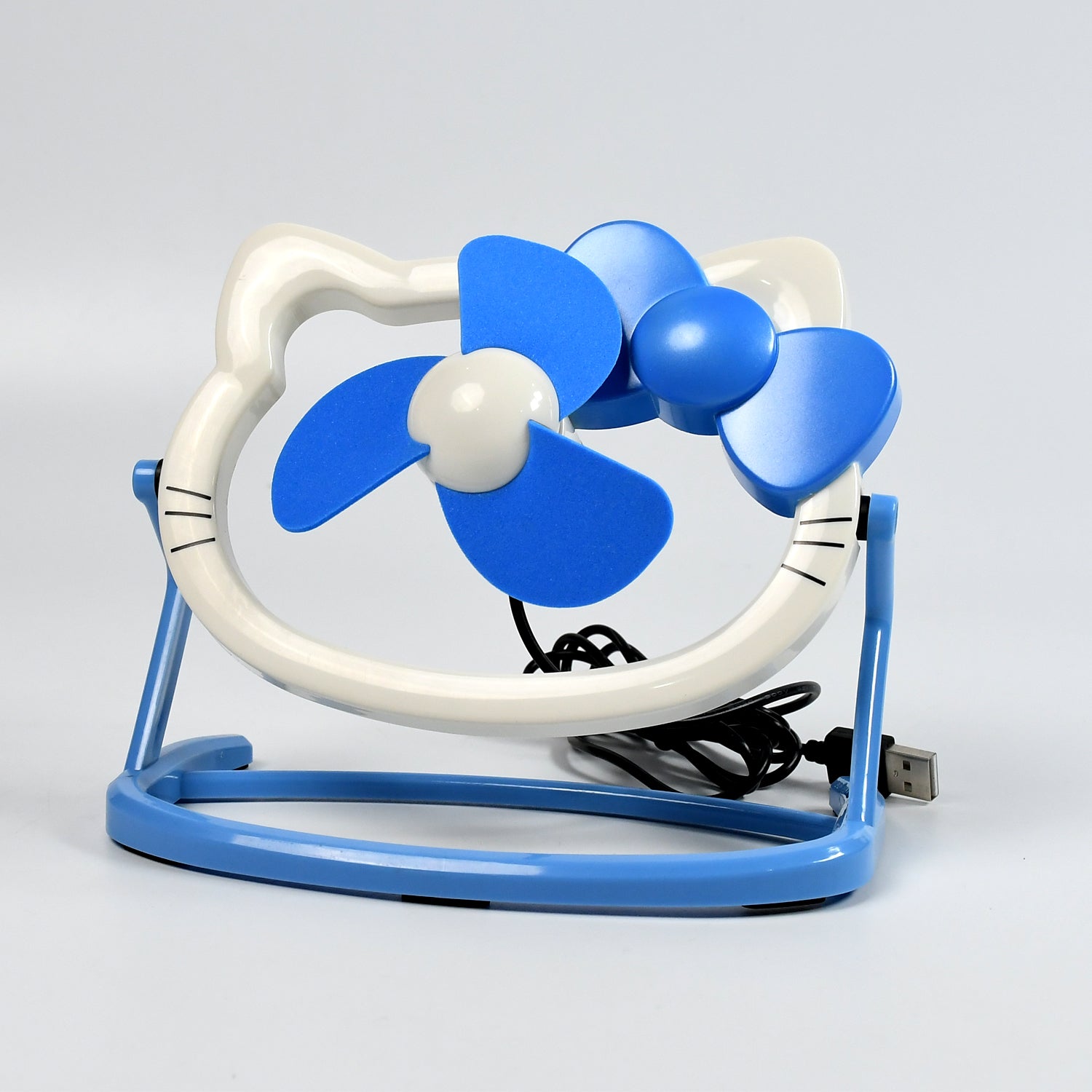 USB Mini Fan running silently on a desk, providing a gentle breeze.