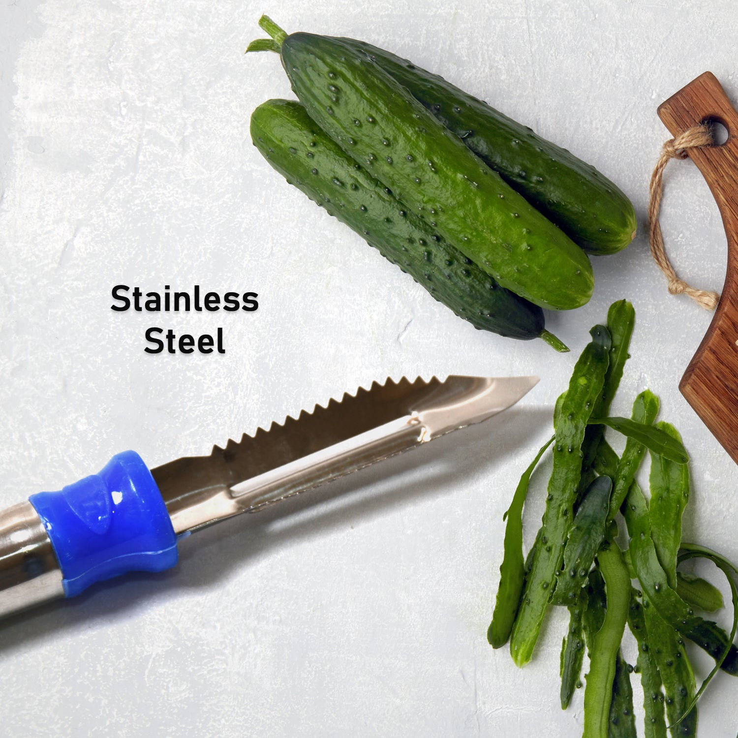 The versatile dual blade fruit peeler displayed with an assortment of freshly peeled vegetables.