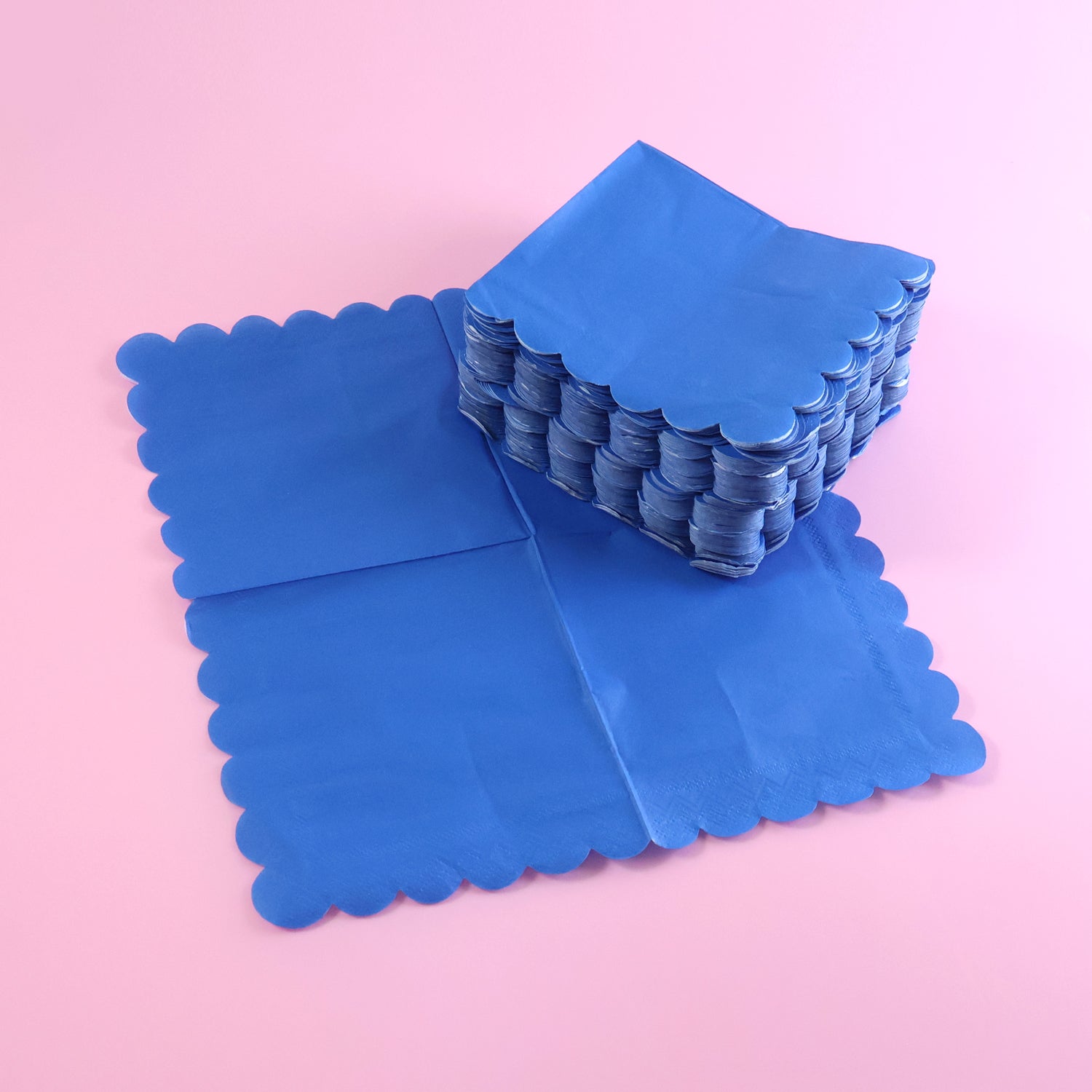 Royal scalloped paper napkin with elegant scalloped edges on party table