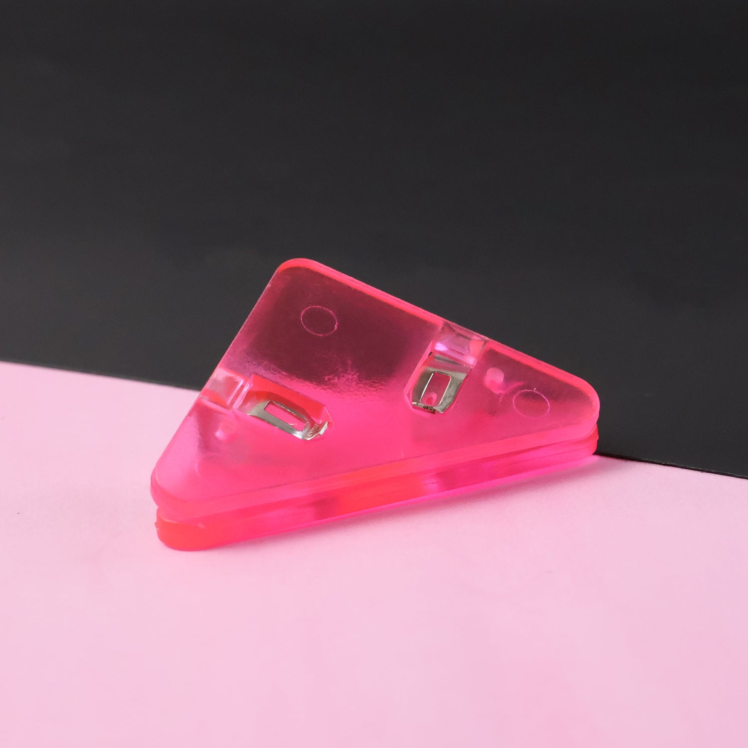 Triangle paper clip protecting paper corner from damage