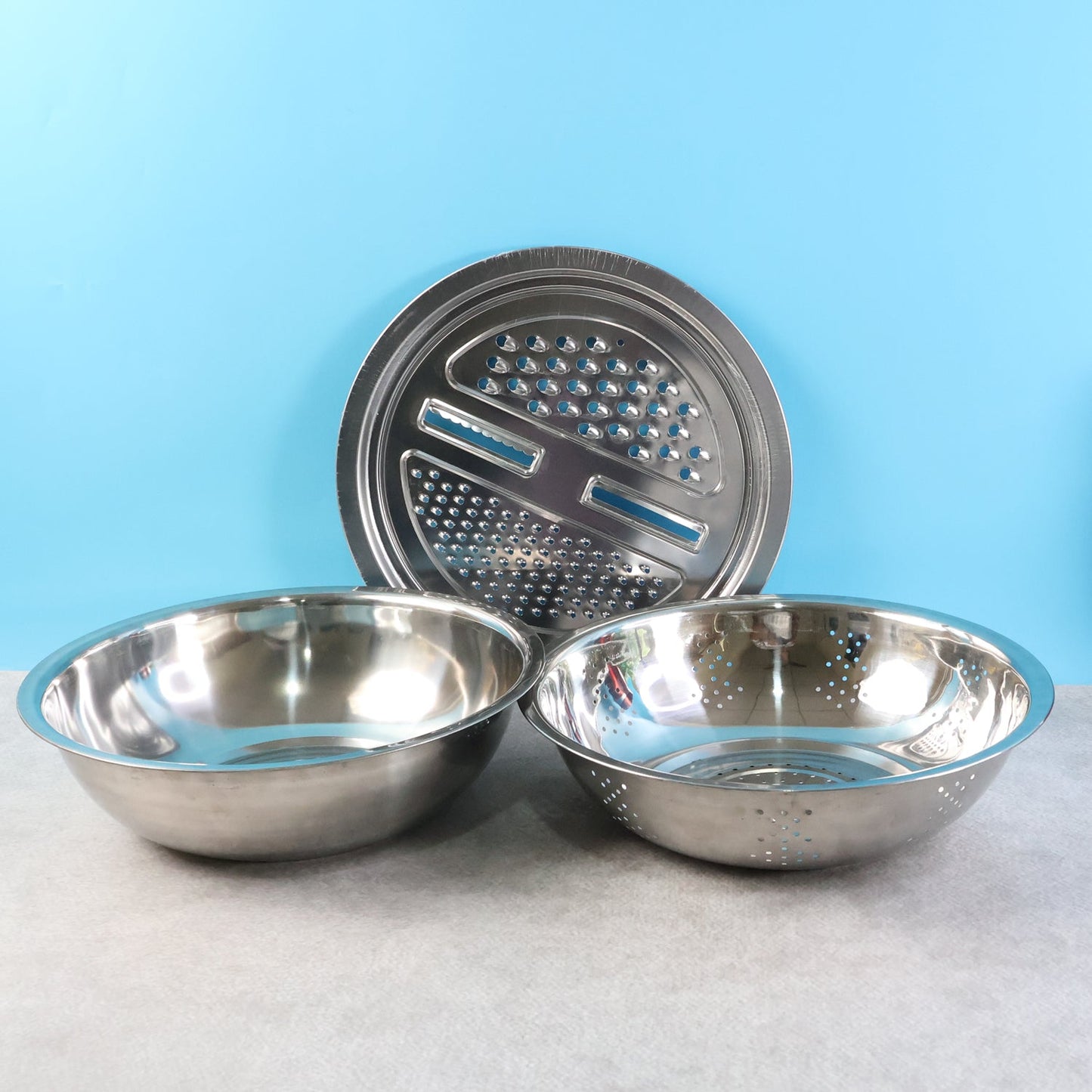 3-in-1 stainless steel mixing bowl set showing mixing, straining, and grating functions