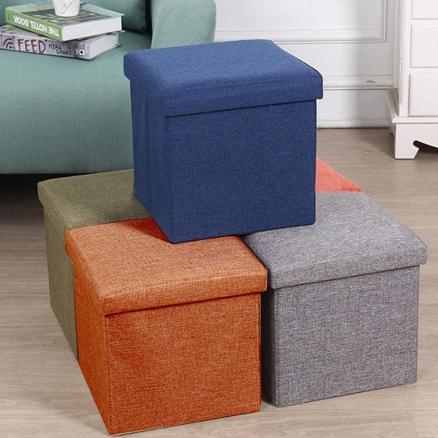A versatile storage stool serving as a footrest next to a sofa, highlighting its multipurpose use.