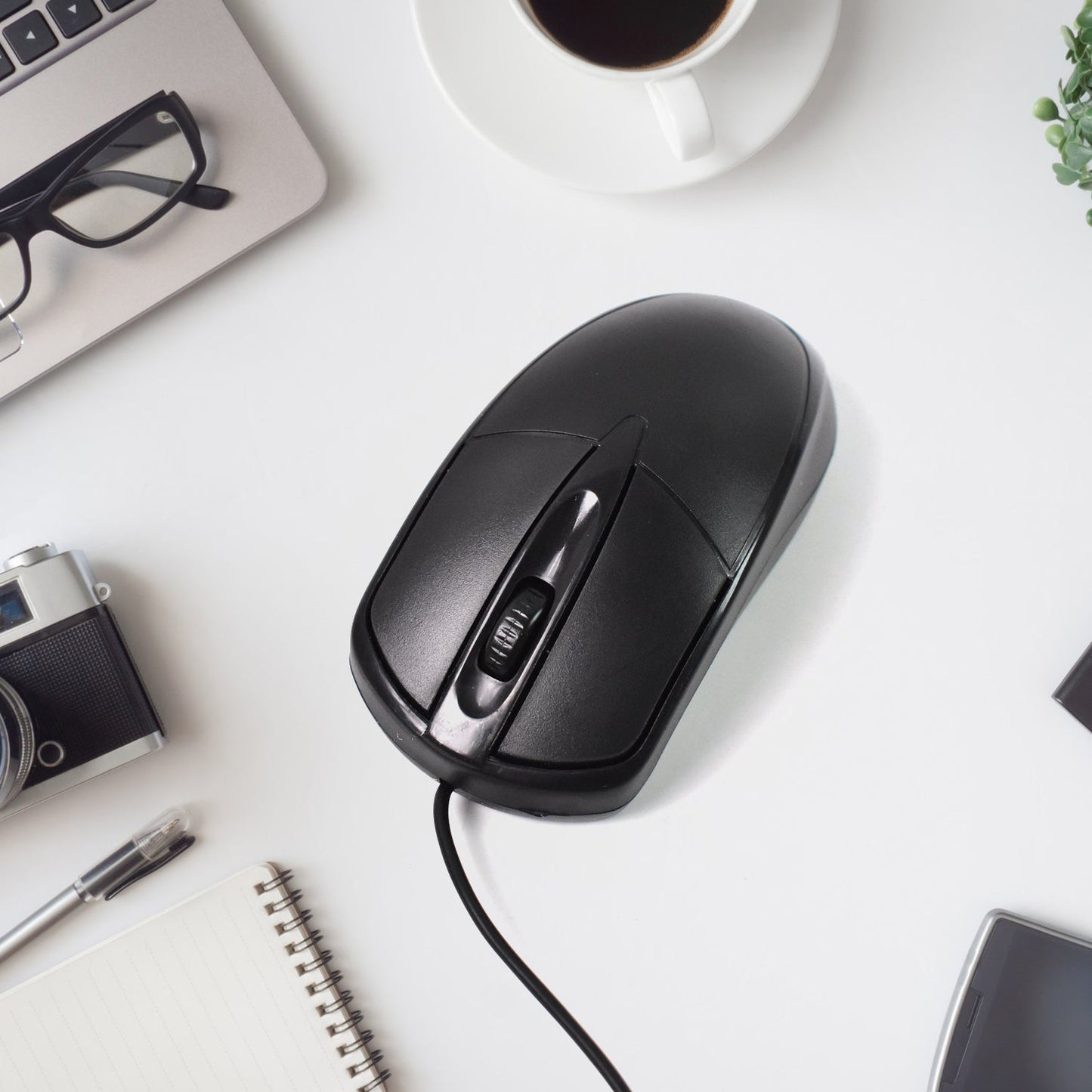 Top-down view of the black wired optical mouse, showcasing its simple and functional layout.