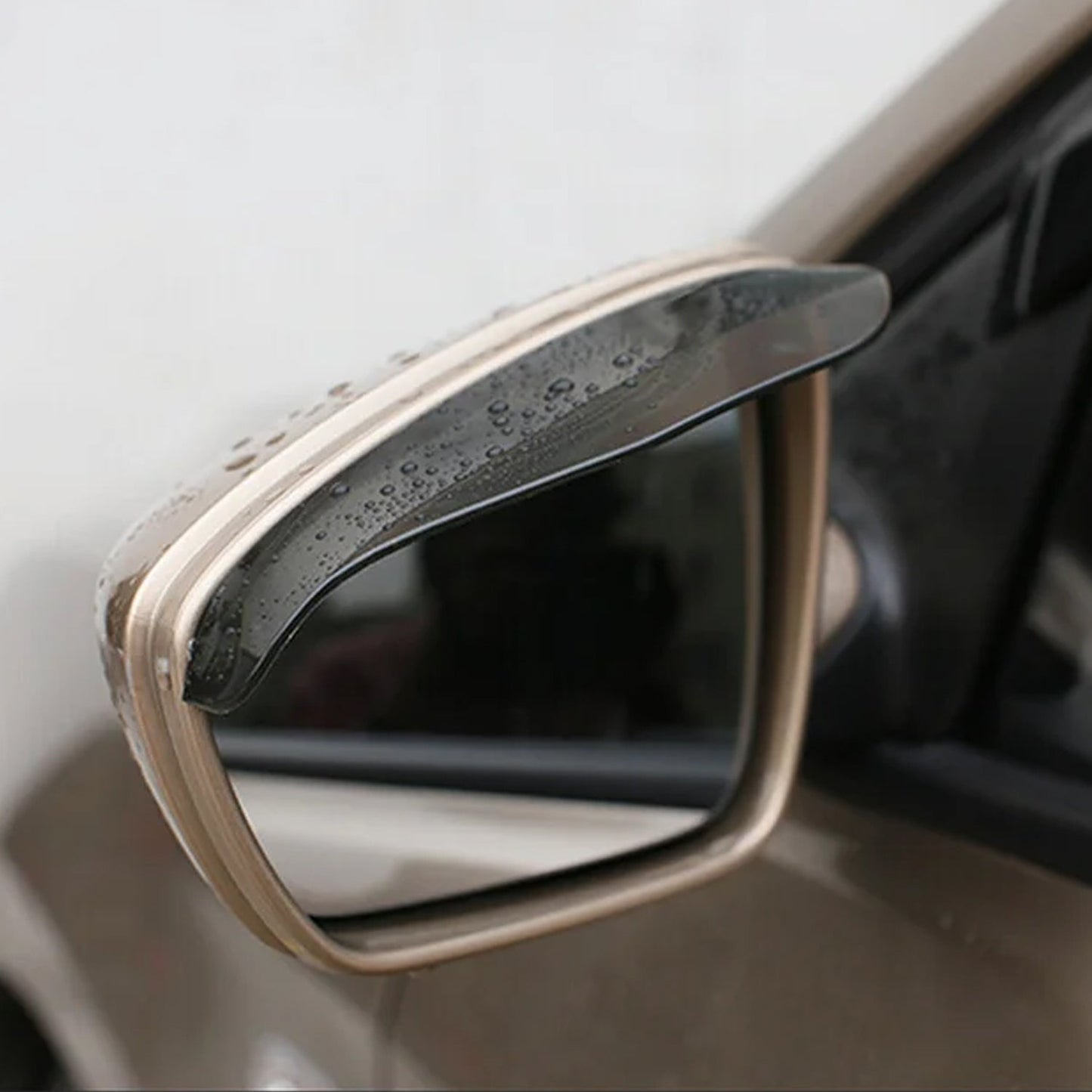 Rearview mirror of a car with the rain protector cover securely installed.