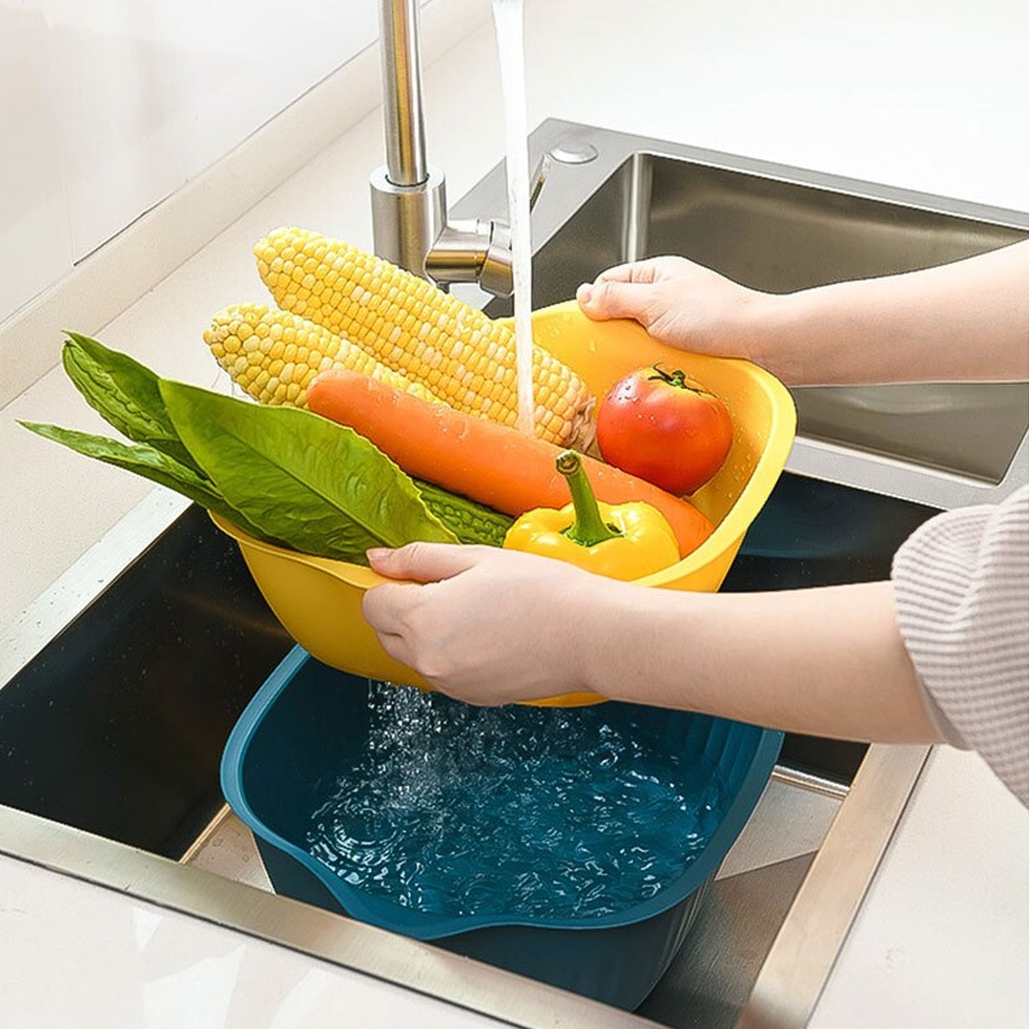 Plastic washing bowl with integrated strainer, perfect for kitchen use.